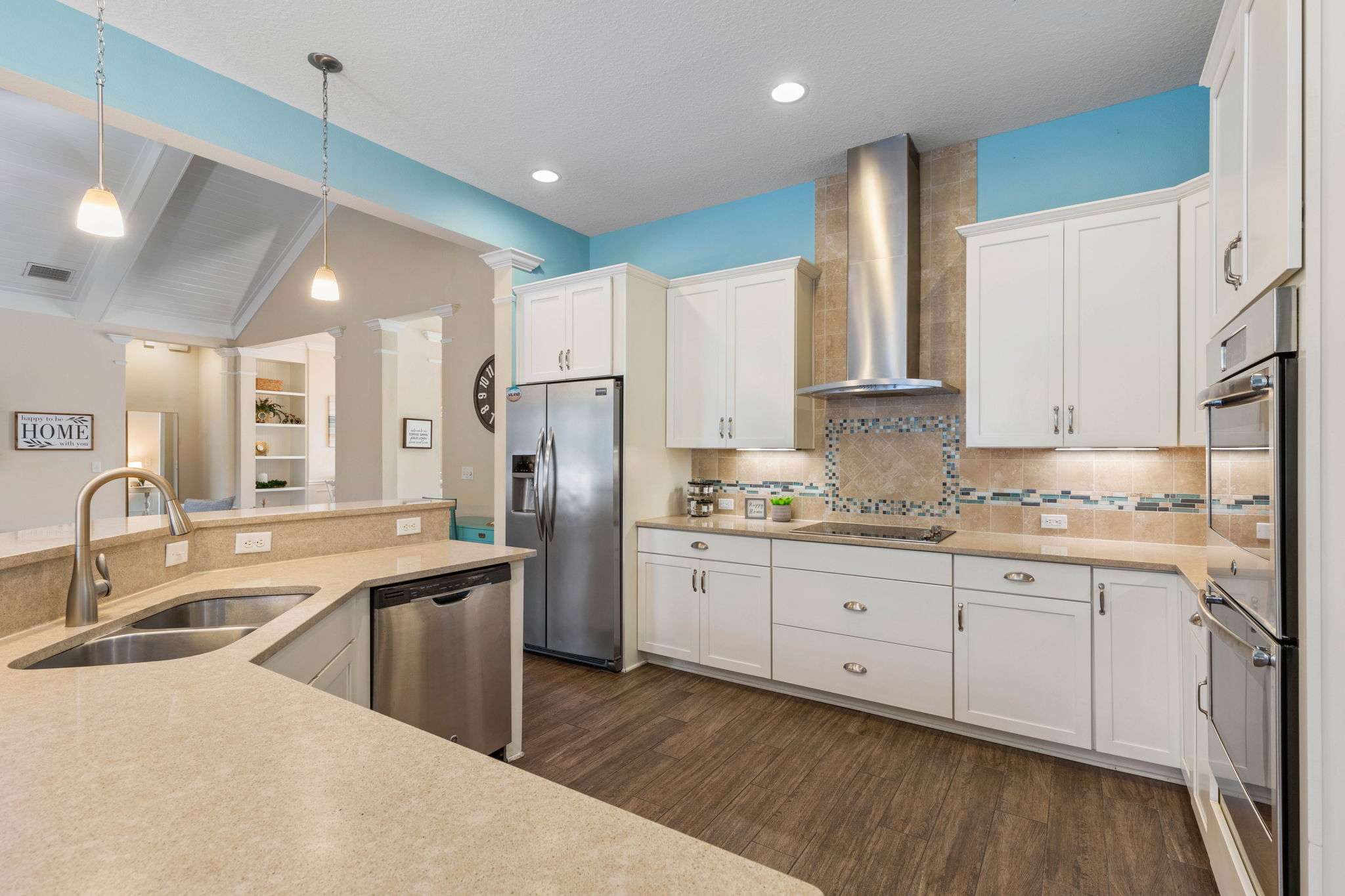 From pancake breakfasts at the wide-open counter to late-night snacks after the pool, this bright coastal kitchen keeps everyone connected, with room to cook, gather, pour another drink, and savor the kind of easy vacation days that linger.