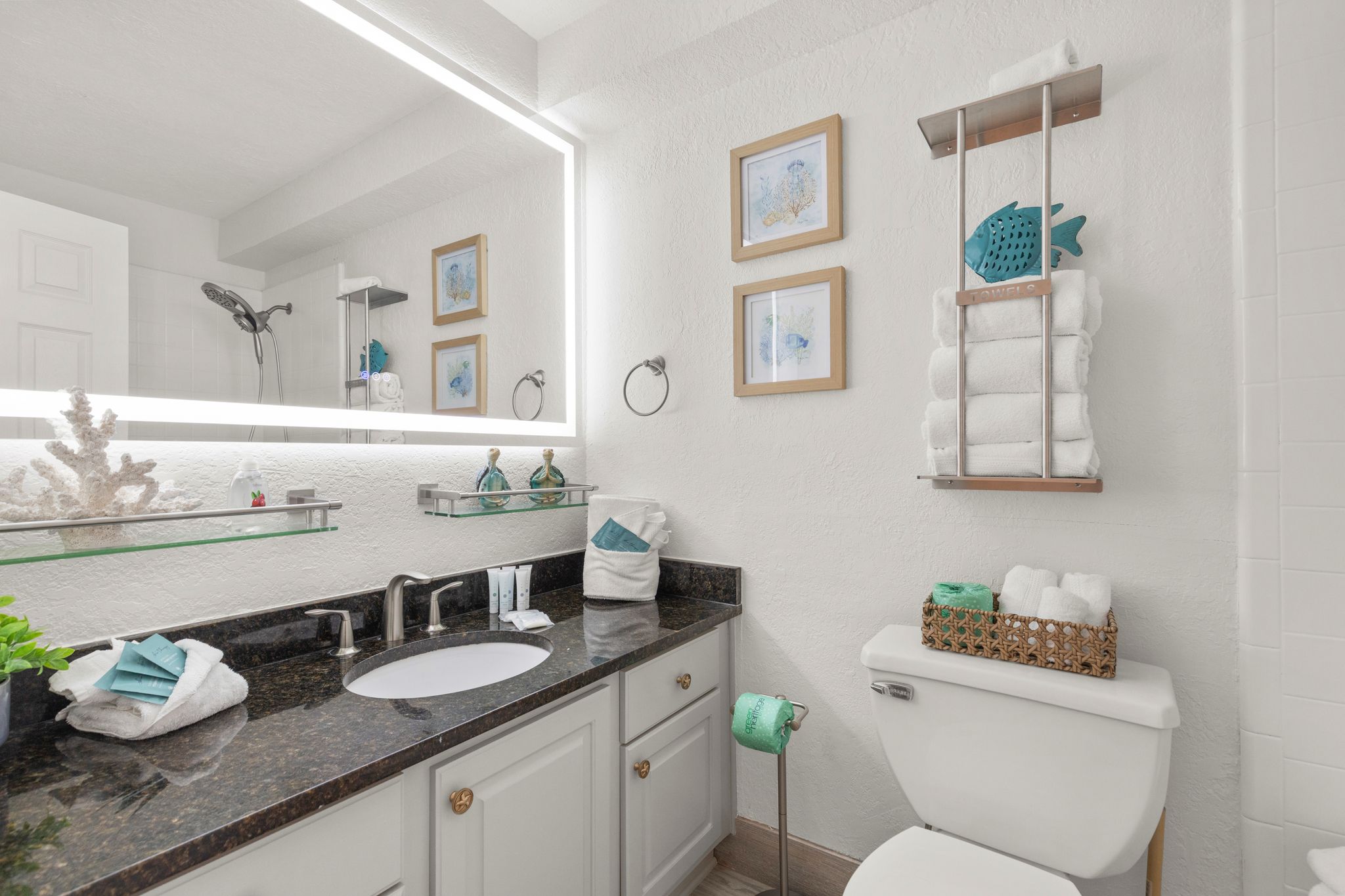 Guest bathroom with a tub/shower combo, styled with a hotel-style shower curtain, plush towels, and complimentary toiletries—everything you need for a comfortable, spa-like stay.