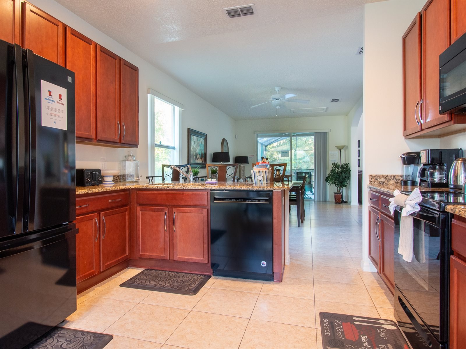 Fully stocked kitchen with granite countertops, stainless steel appliances, breakfast bar, and breakfast nook.
