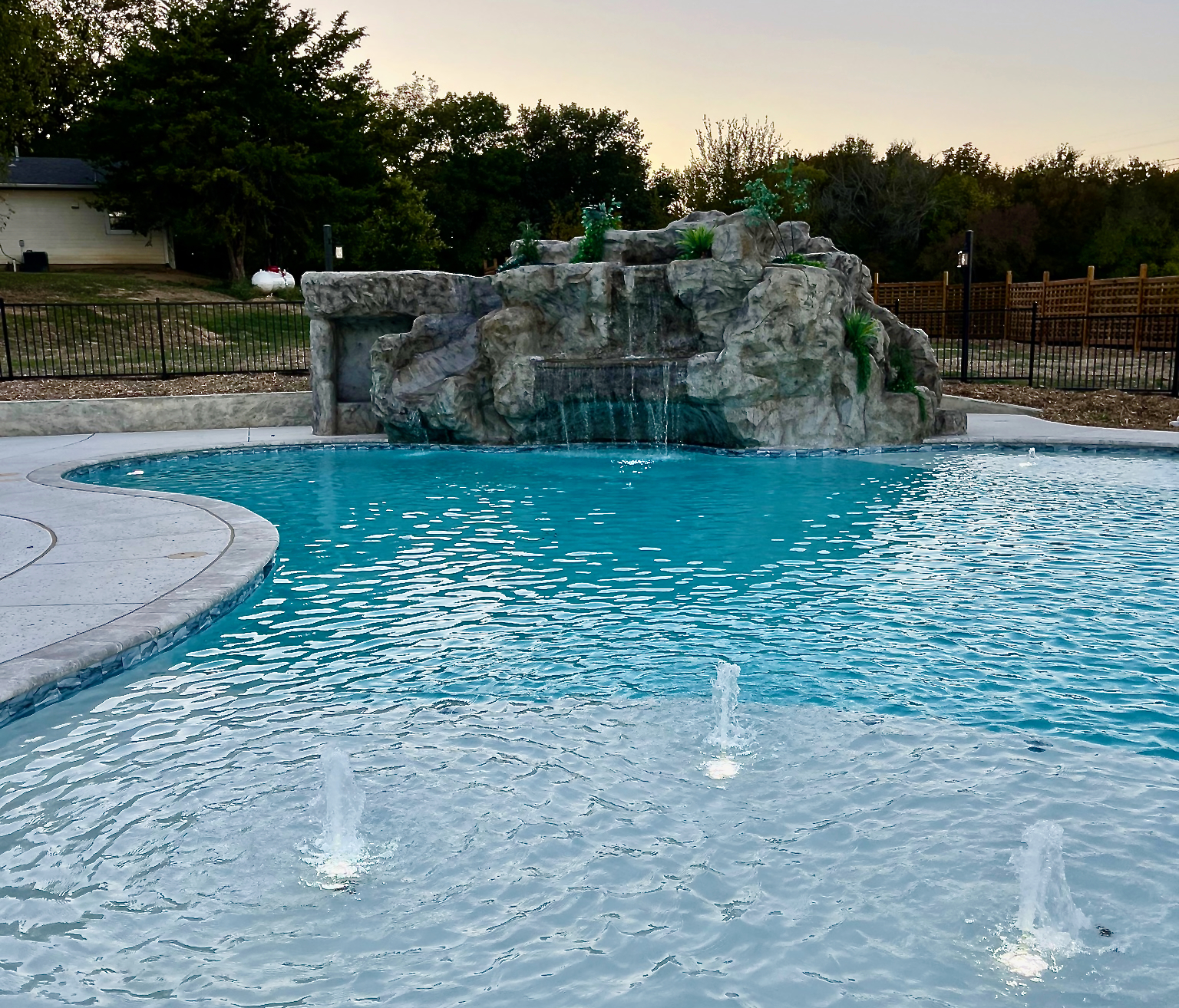 Resort style 30,000-gallon saltwater pool with double waterfalls and grotto and slide