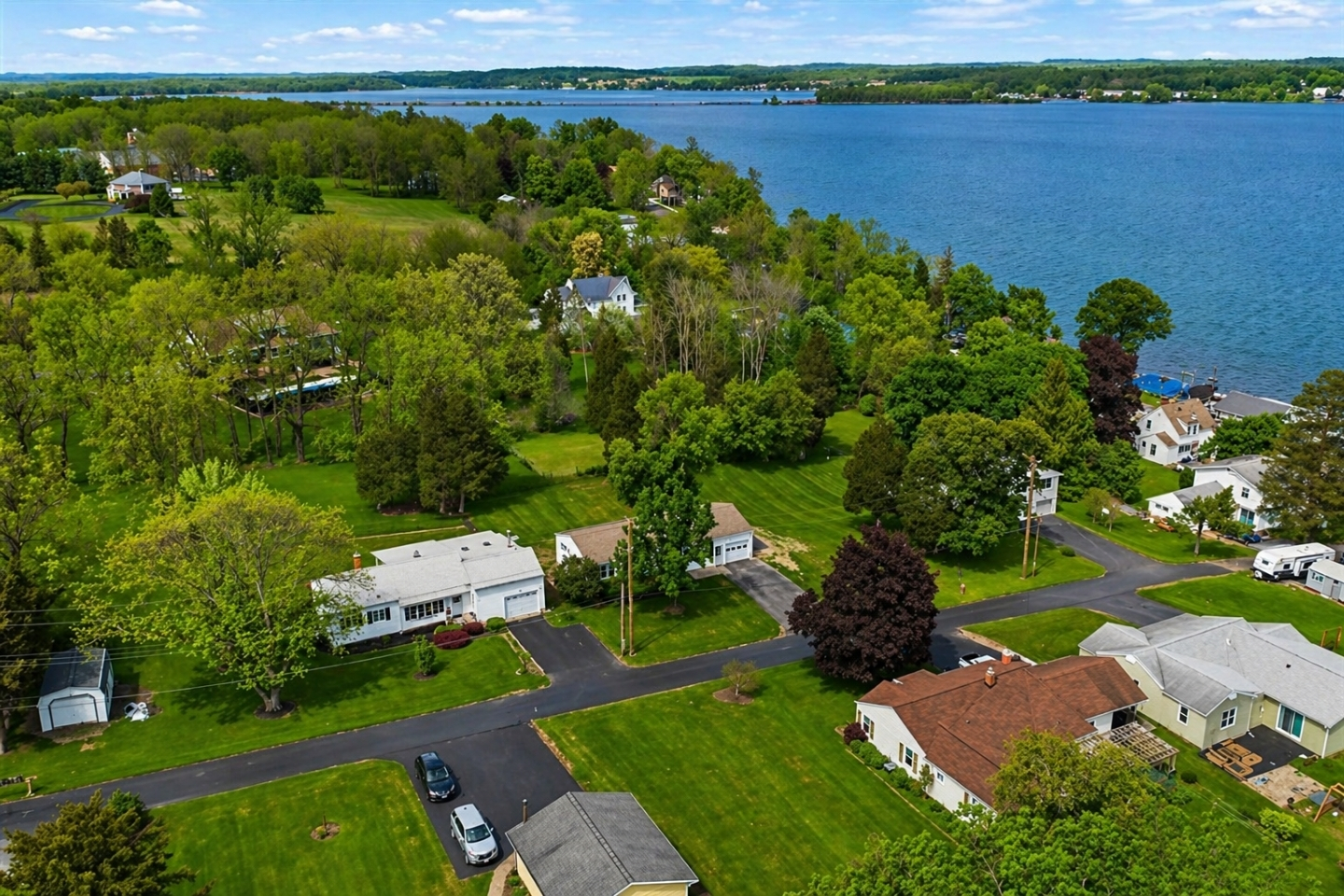 Beautiful aerial view of a lakeside community with lush greenery and serene water. Perfect for those seeking tranquility and picturesque surroundings.