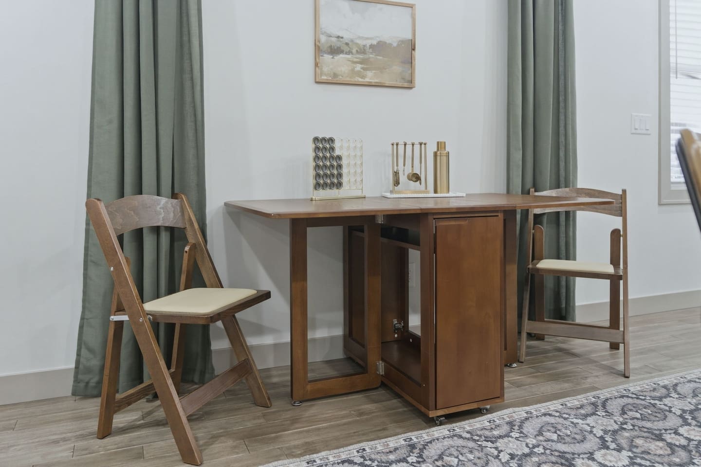 Charming dining nook with a versatile drop-leaf table and seating for two—ideal for breakfast, coffee, or a quiet meal.