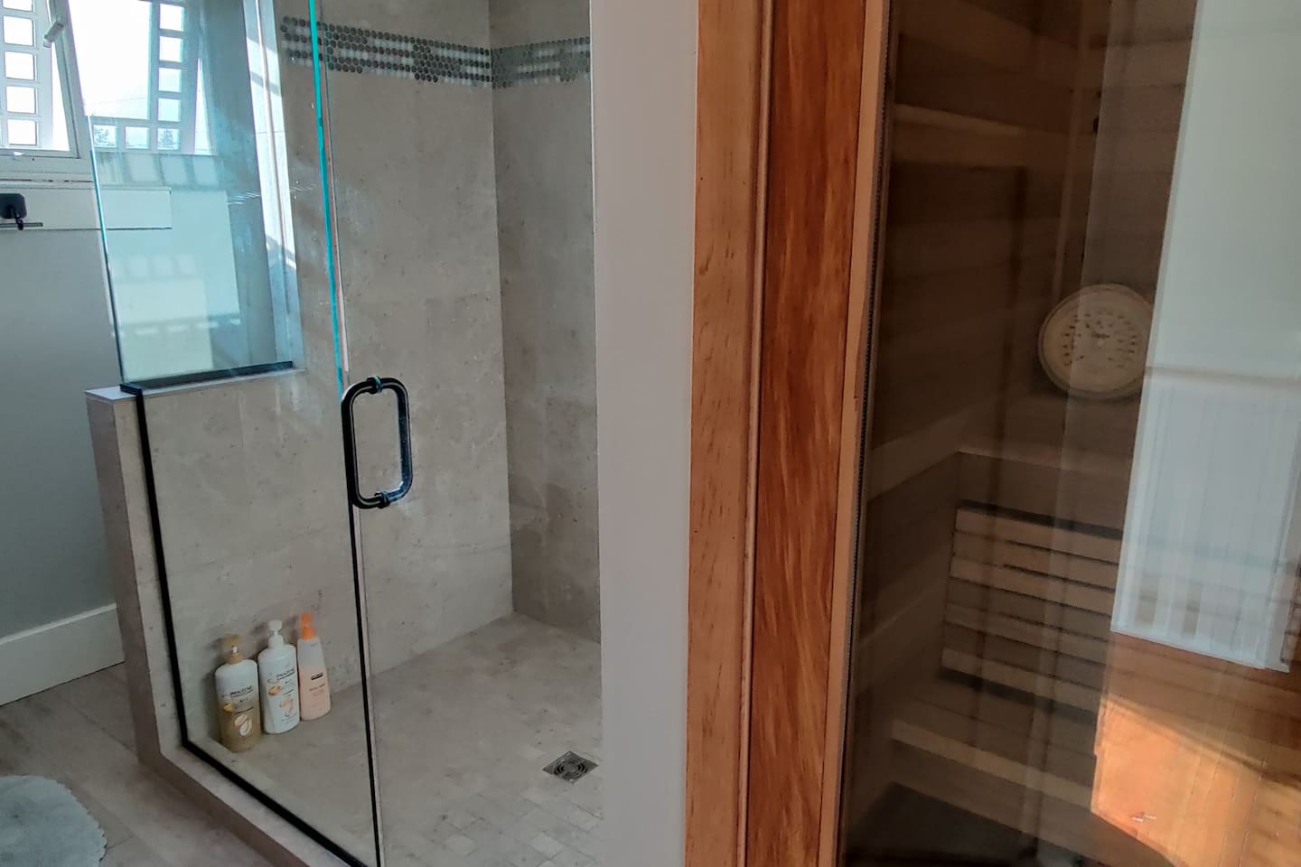 Updated second-floor bathroom with walk-in shower and a sauna. 