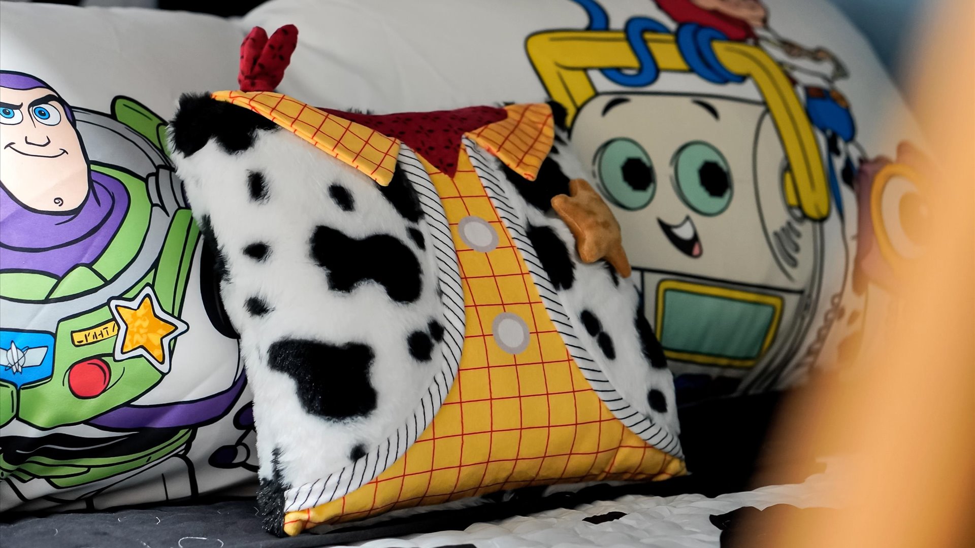 Toy Story Adventure Detail: Playful Woody decorative pillow adds another themed touch to this immersive Toy Story bedroom.