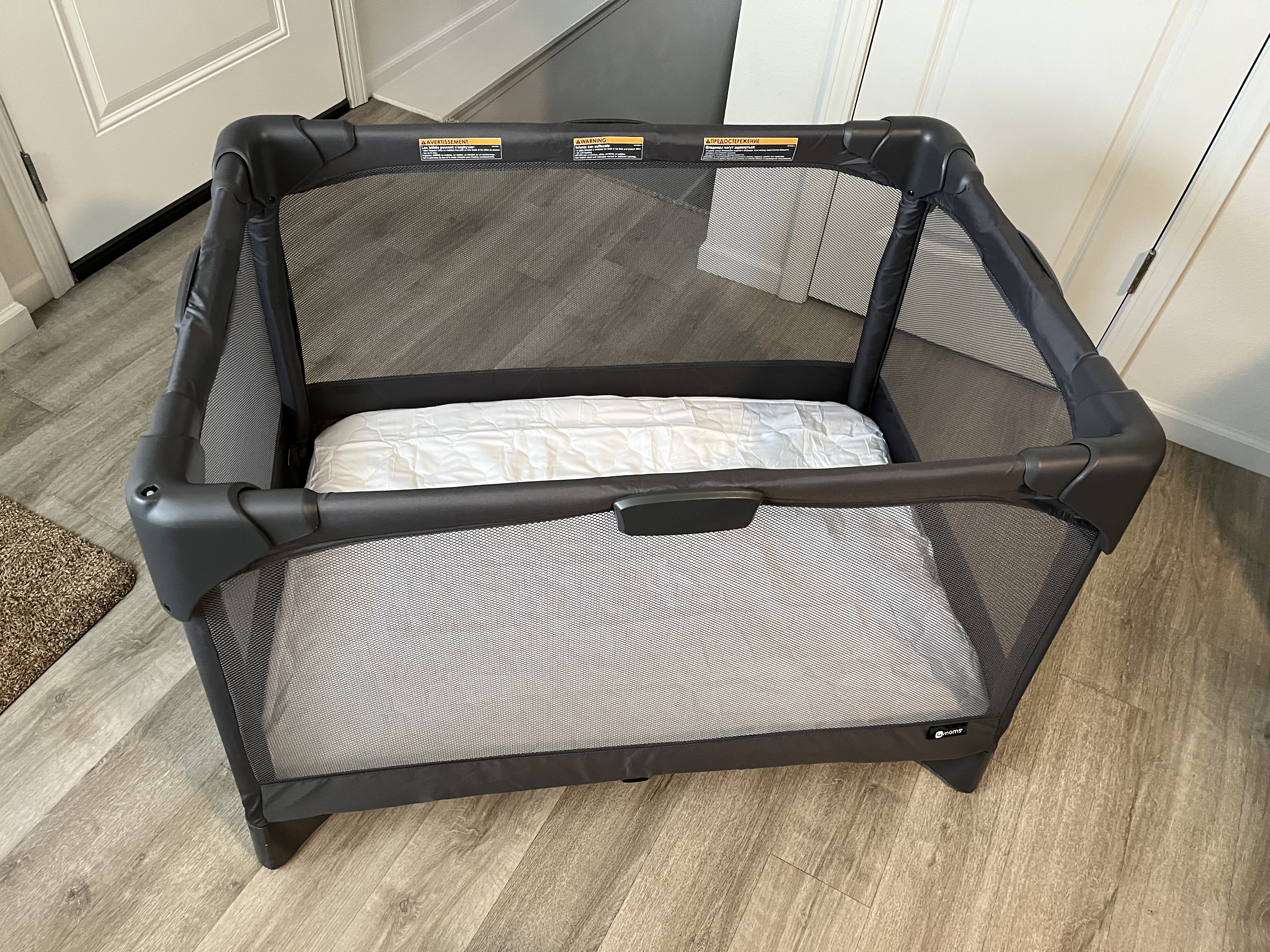 Portable play and mattress cover provided. Located in main floor closet in black carry case.