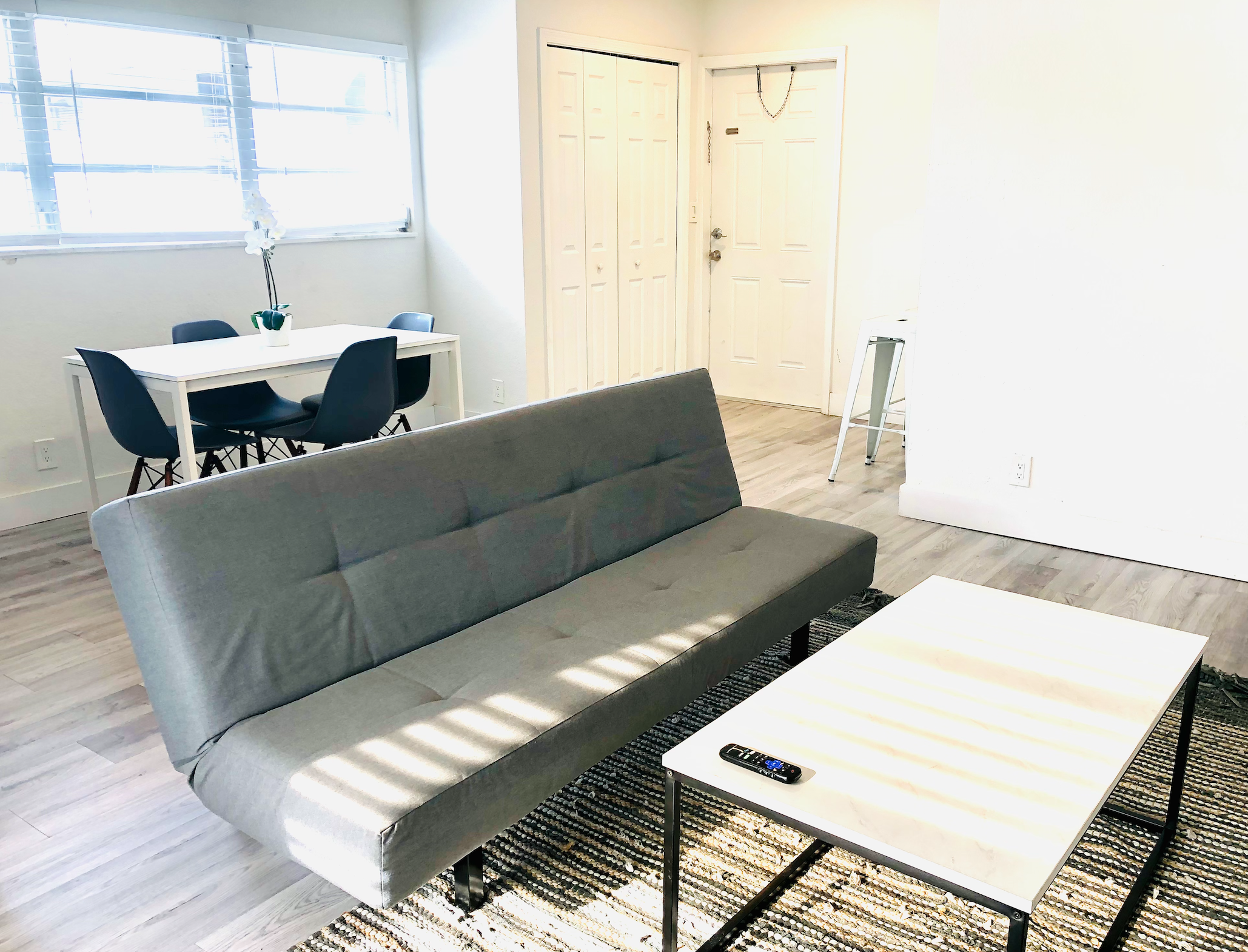 Alternate view of lounge chair and dining set. Futon replaced with queen sofa bed that sleeps two guests.