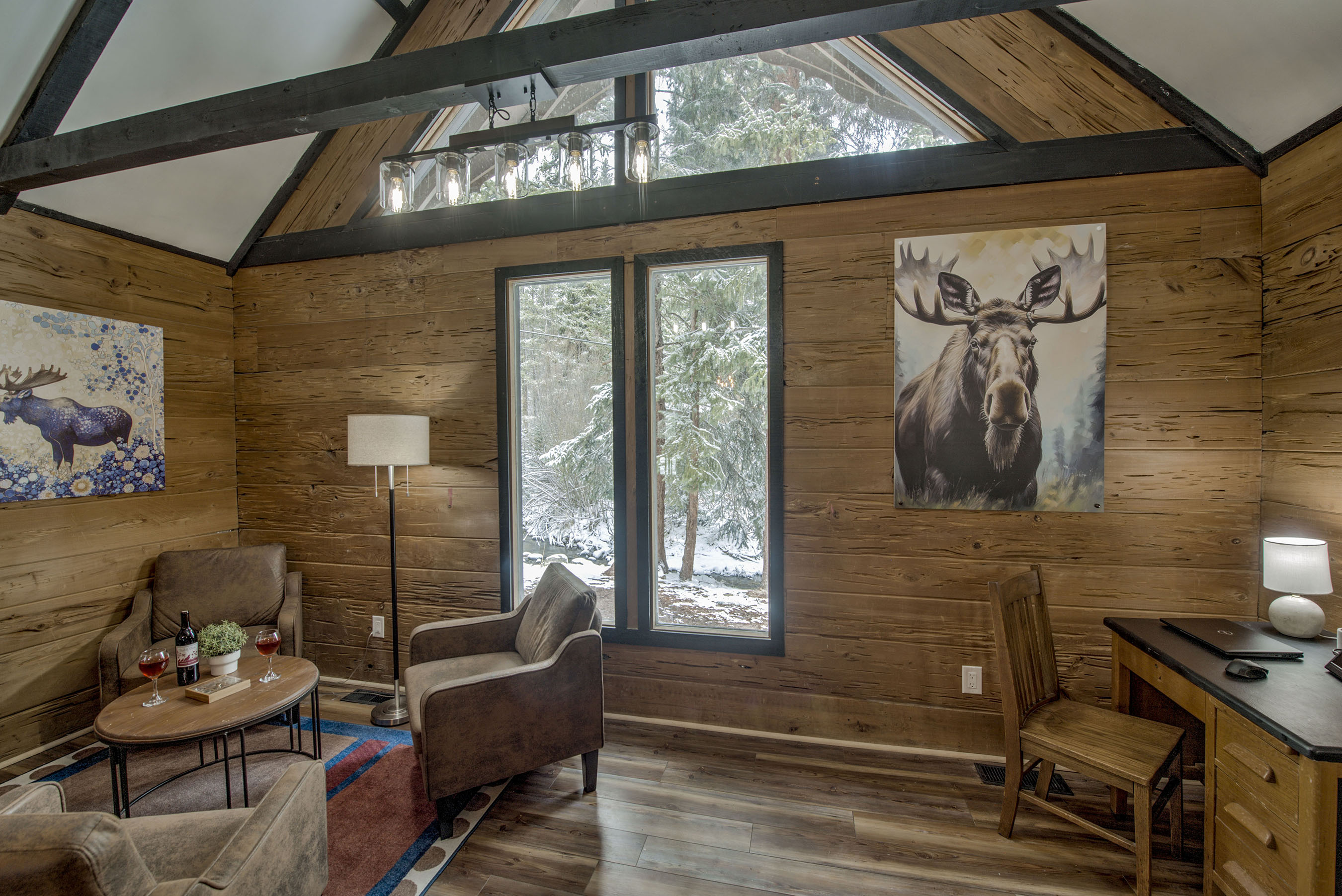 Relax in your light-filled retreat—vaulted ceilings, forest views, and cozy seating create a peaceful space for you to unwind and make it yours.