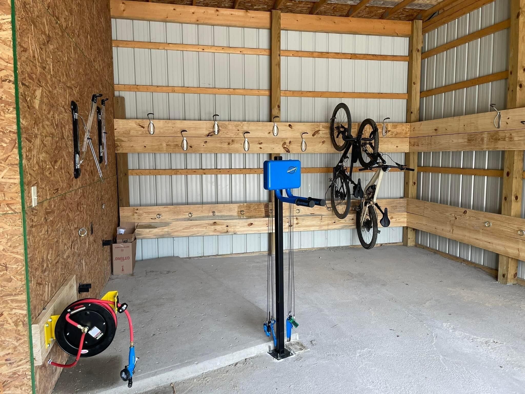Bike Storage with air compressor, work station and e-bike charging.