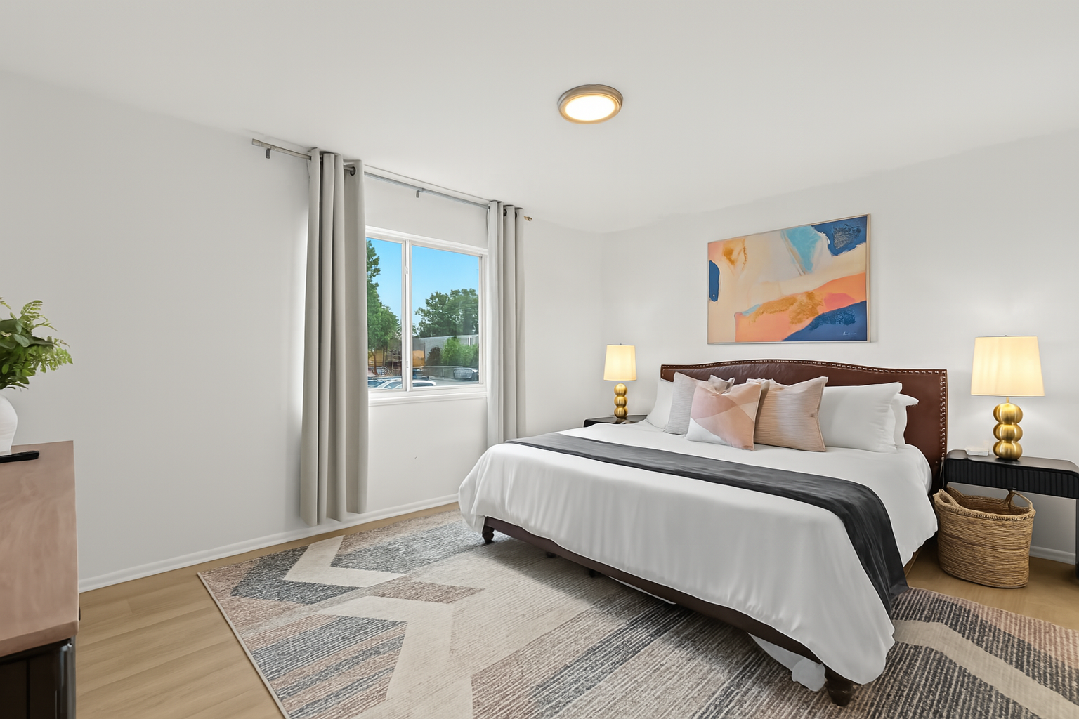 Bright and airy bedroom with large windows, a king bed, and modern art for a peaceful vibe.