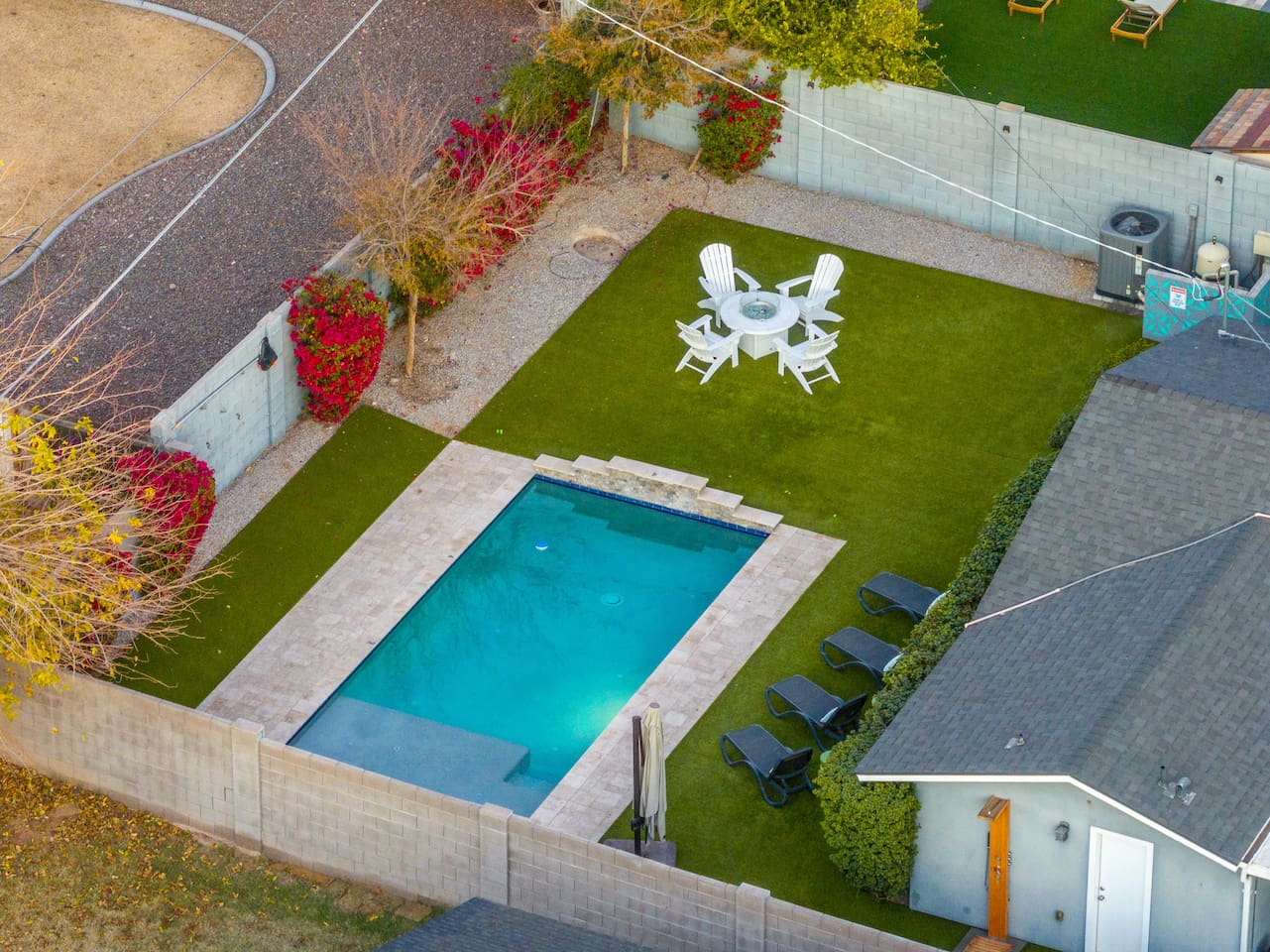 Aerial view highlighting the beauty of our poolside, with its sparkling water, comfortable seating, and surrounding greenery, creating a peaceful retreat.