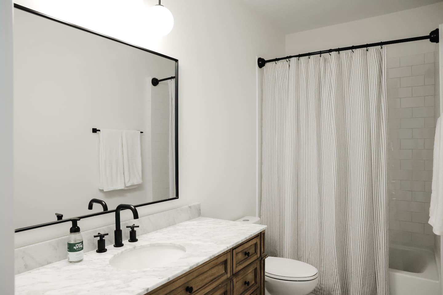 The "rose room" features a queen bed, accents from CB2, a desk for work-from-home, smart TV, a spacious double-door closet and a full bath with a shower tub. 