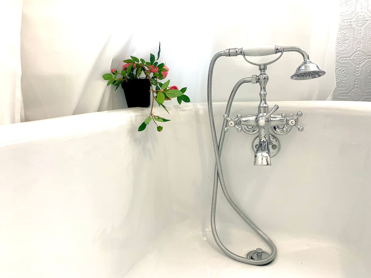 Full bathroom with the original refinished clawfoot soaker tub, hand held shower nozzle, vanity, and fresh towels provided. 