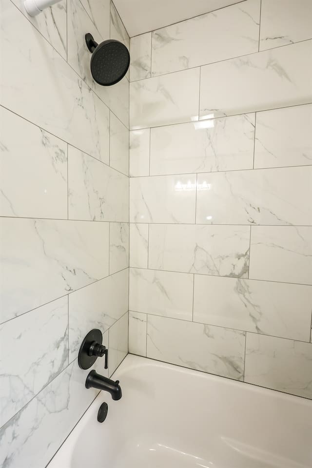 A stylish full bathroom with a shower tub, featuring a minimalist design that emphasizes simplicity and comfort.