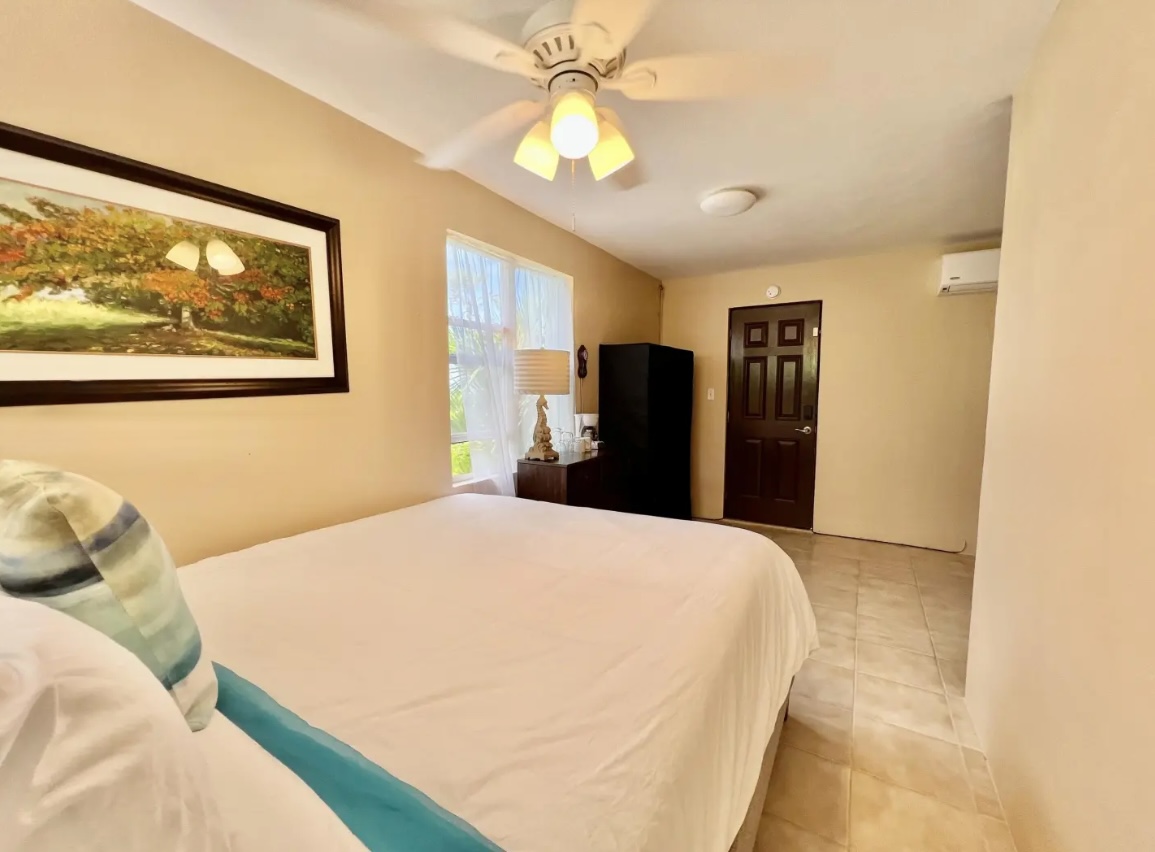 Island-inspired bedroom with cozy bedding and warm lighting—comfortable and inviting.