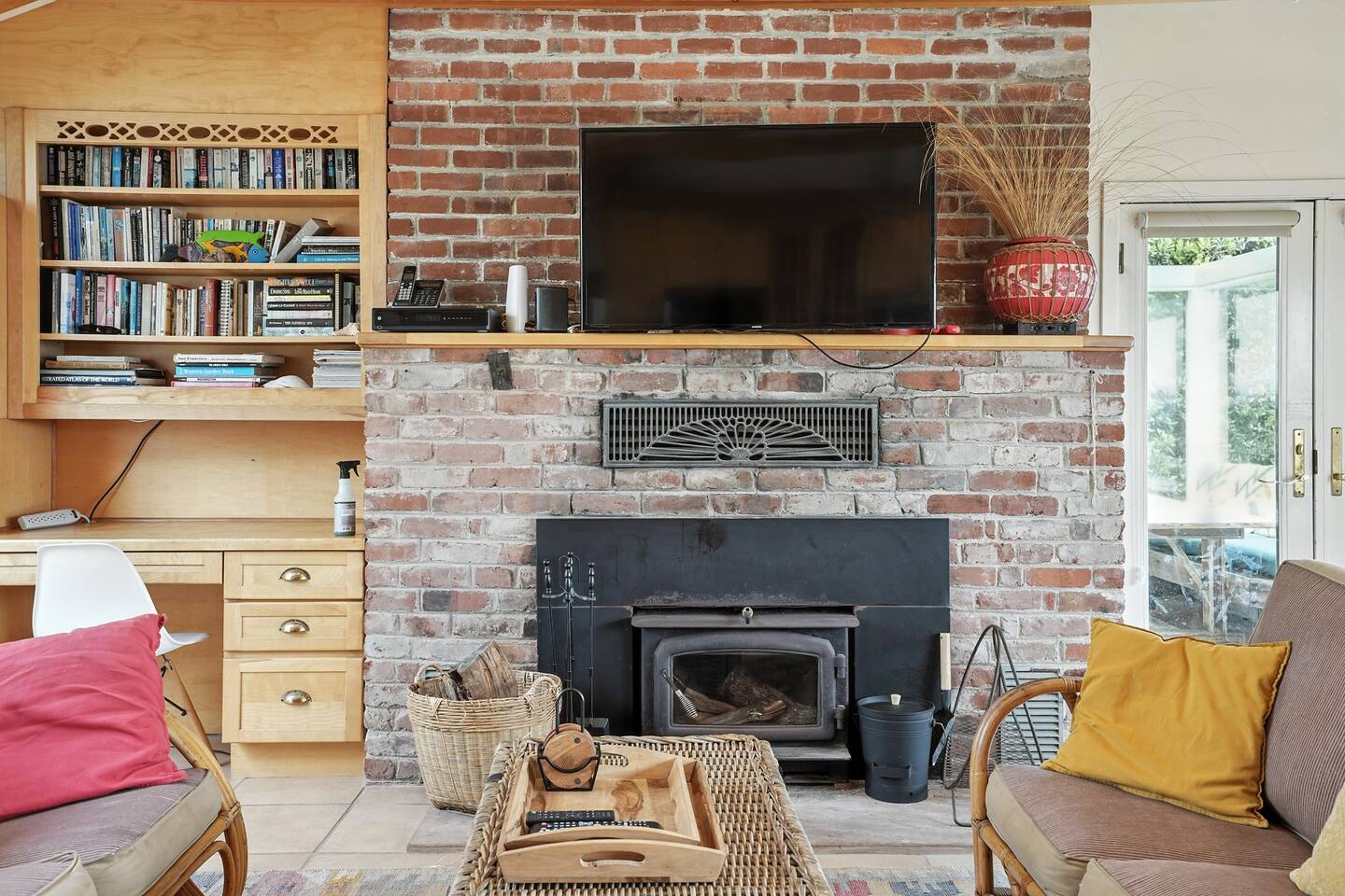- Cozy living space with brick fireplace, mounted TV, and built in bookshelves  
- Comfortable seating and warm accents make it perfect for relaxation  
- Ideal for unwinding with a good book or movie after a day by the coast  