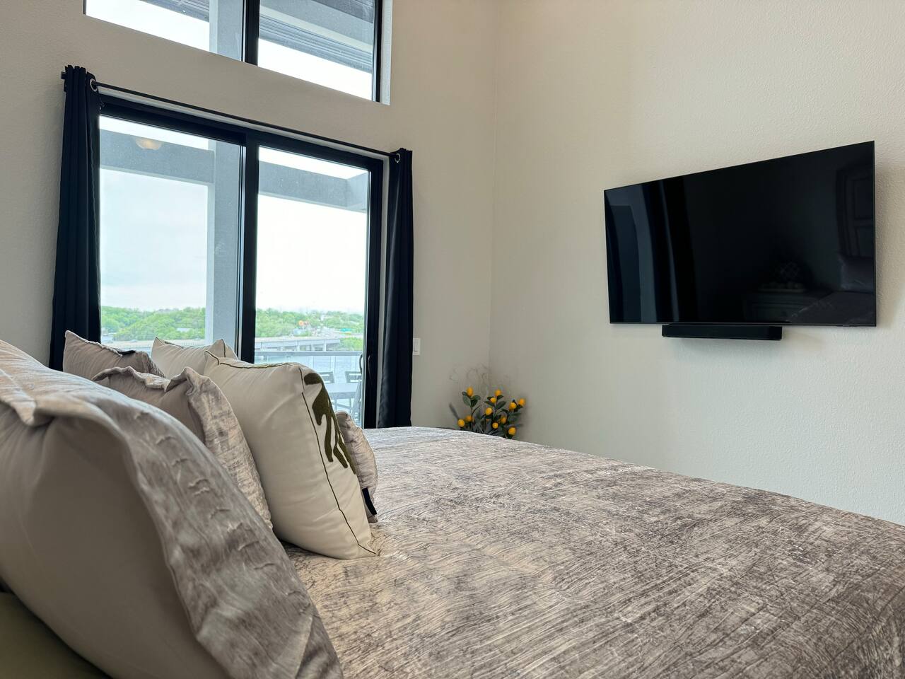 Master bedroom has King bed, night stands, TV with sound system, and slider door access to the balcony. 