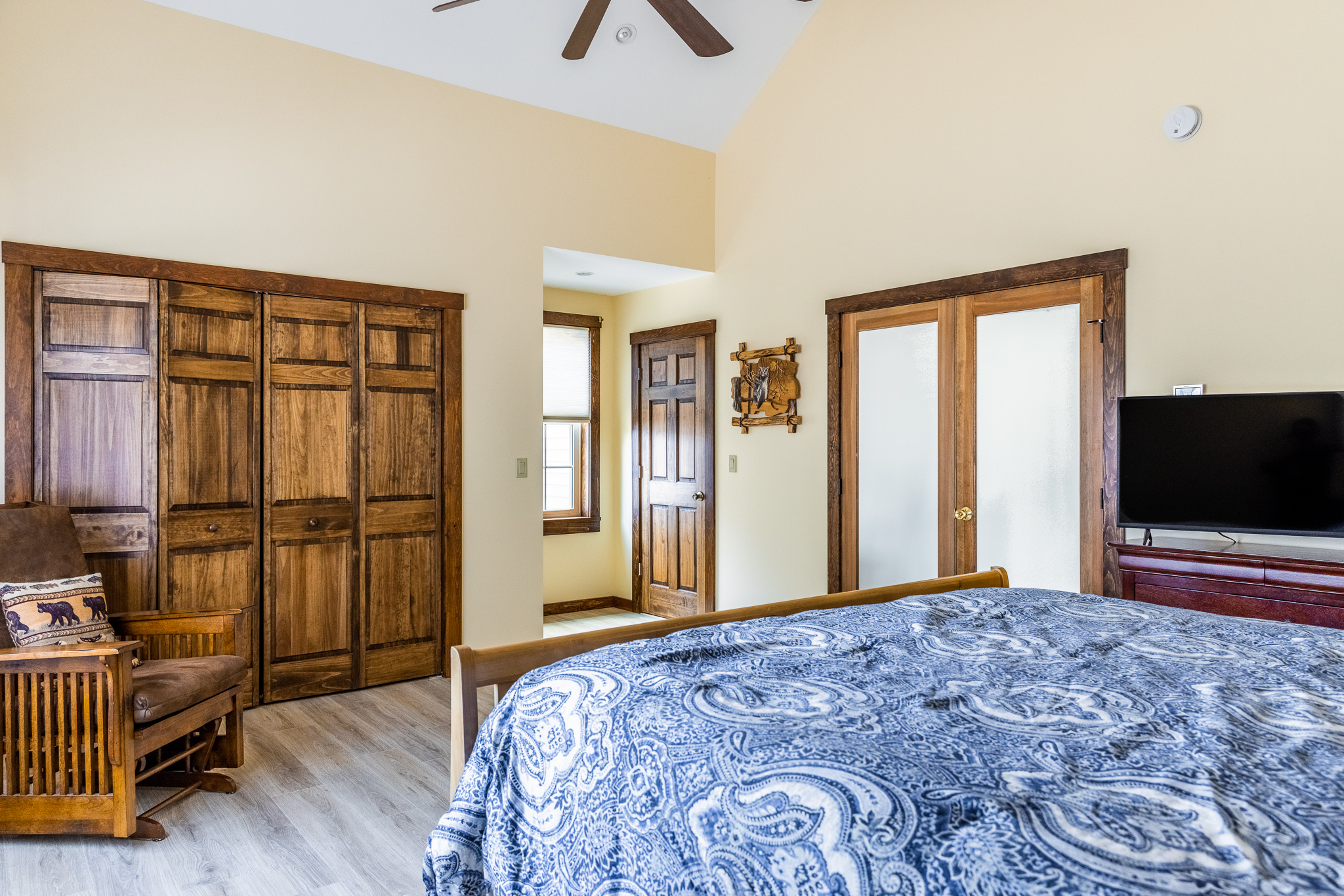 Main floor bedroom, king bed, closet, TV, bathroom.