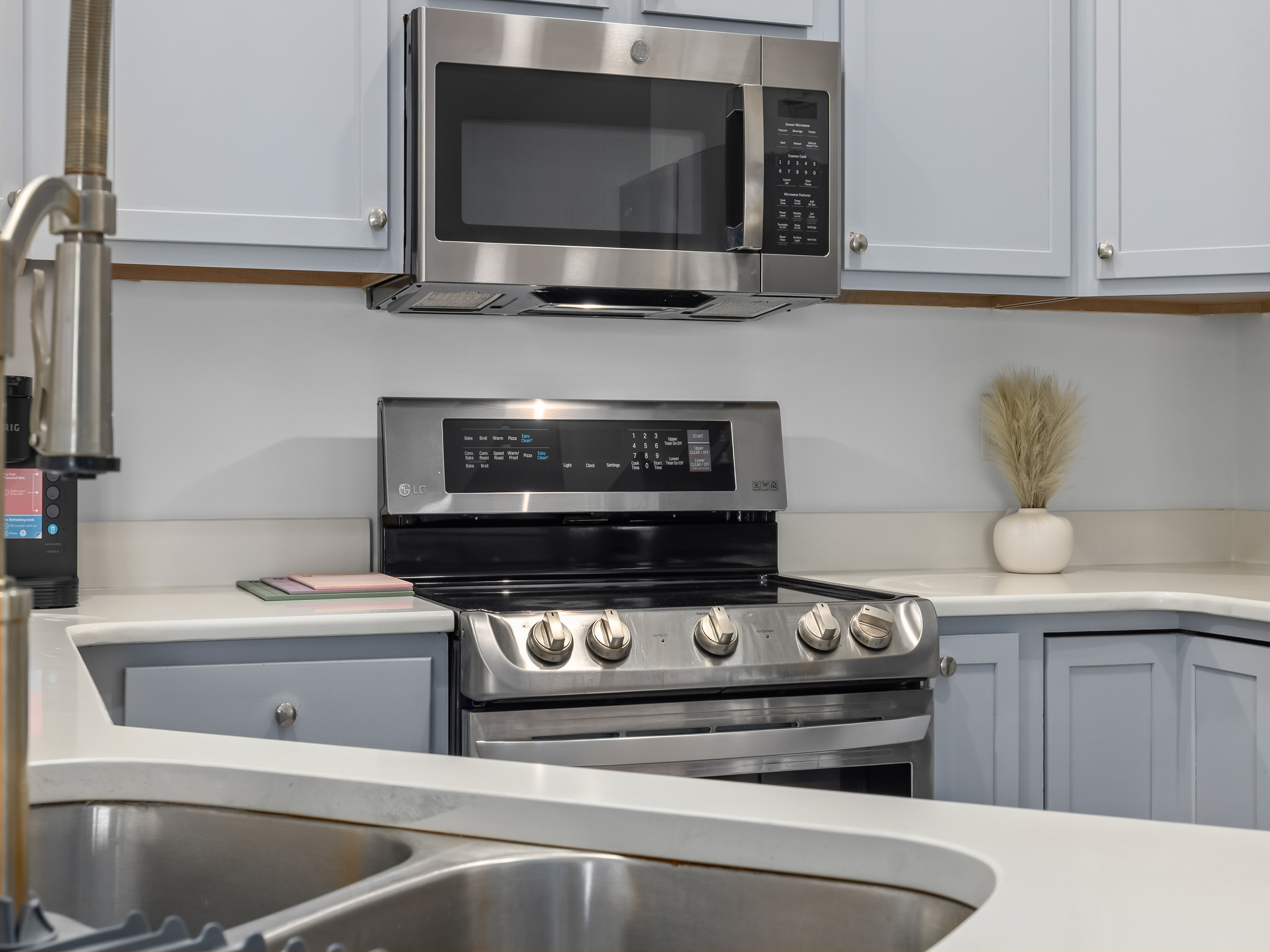 This open-concept kitchen features generous prep space, modern full-size appliances, and casual bar seating — perfect for morning coffee, easy lunches, and evenings spent cooking and connecting. Designed to feel as inviting as it is practical.