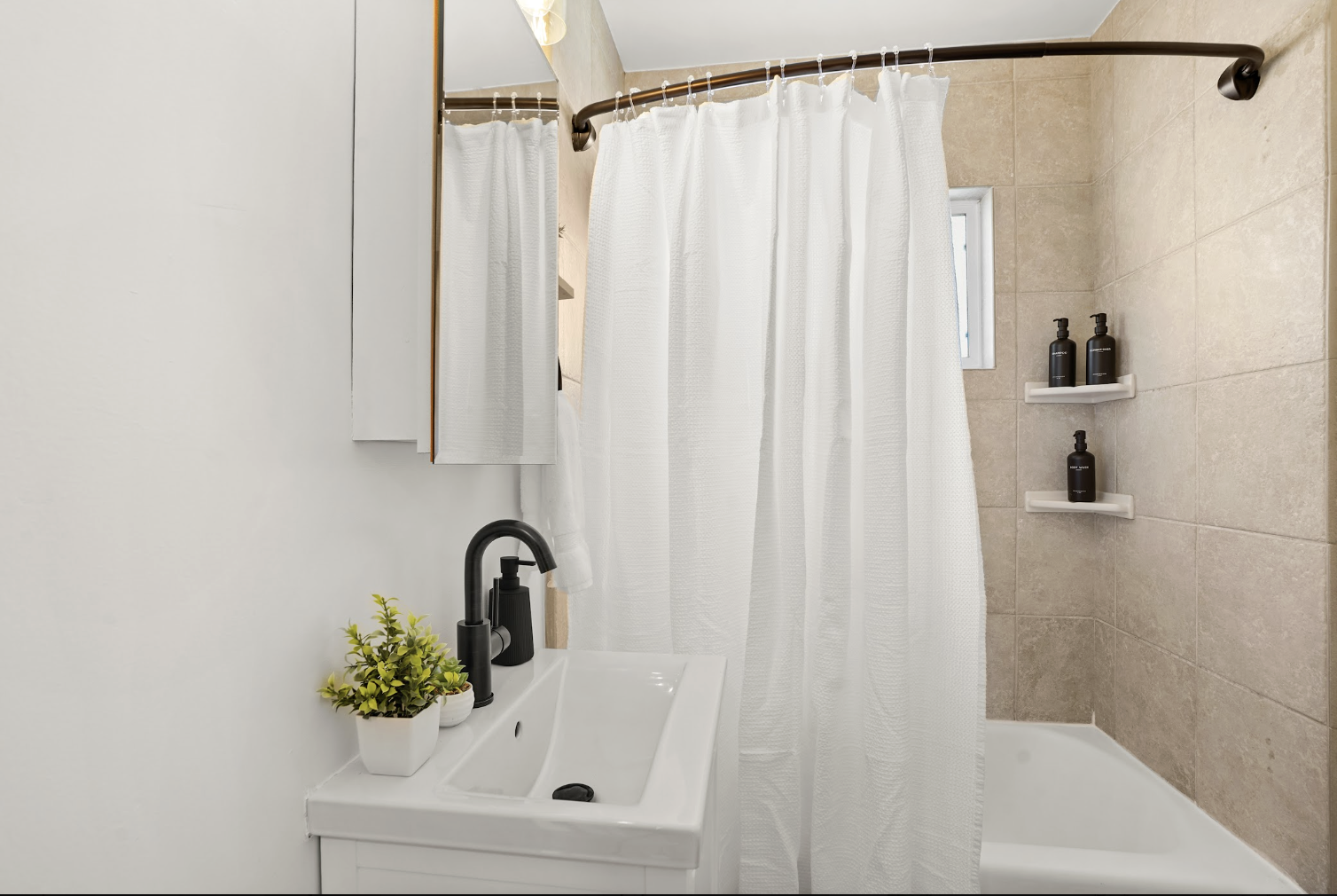Clean contemporary bathroom with a full tub and shower