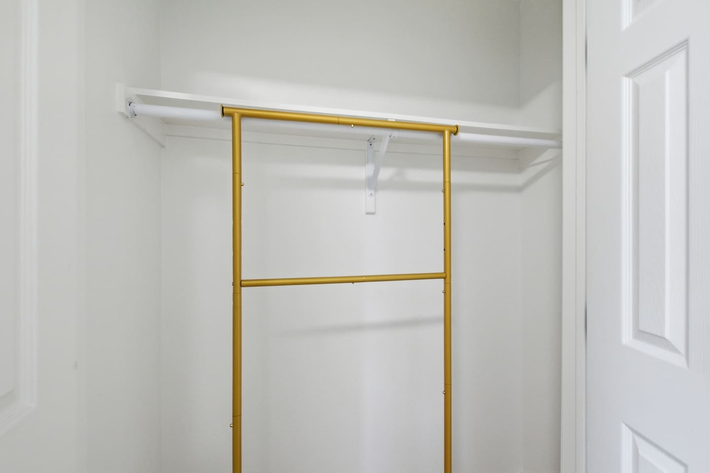 Laundry area with washer, dryer, shelving, and hanging space for extended stays.