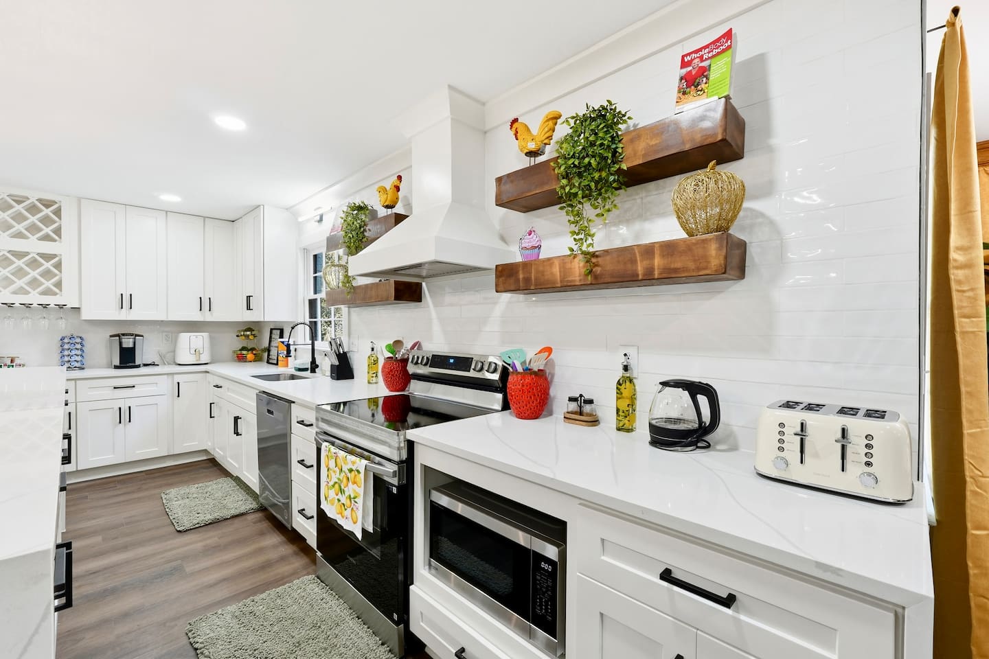 Beautiful white kitchen fully equipped with all the appliances and essentials of a home away from home.