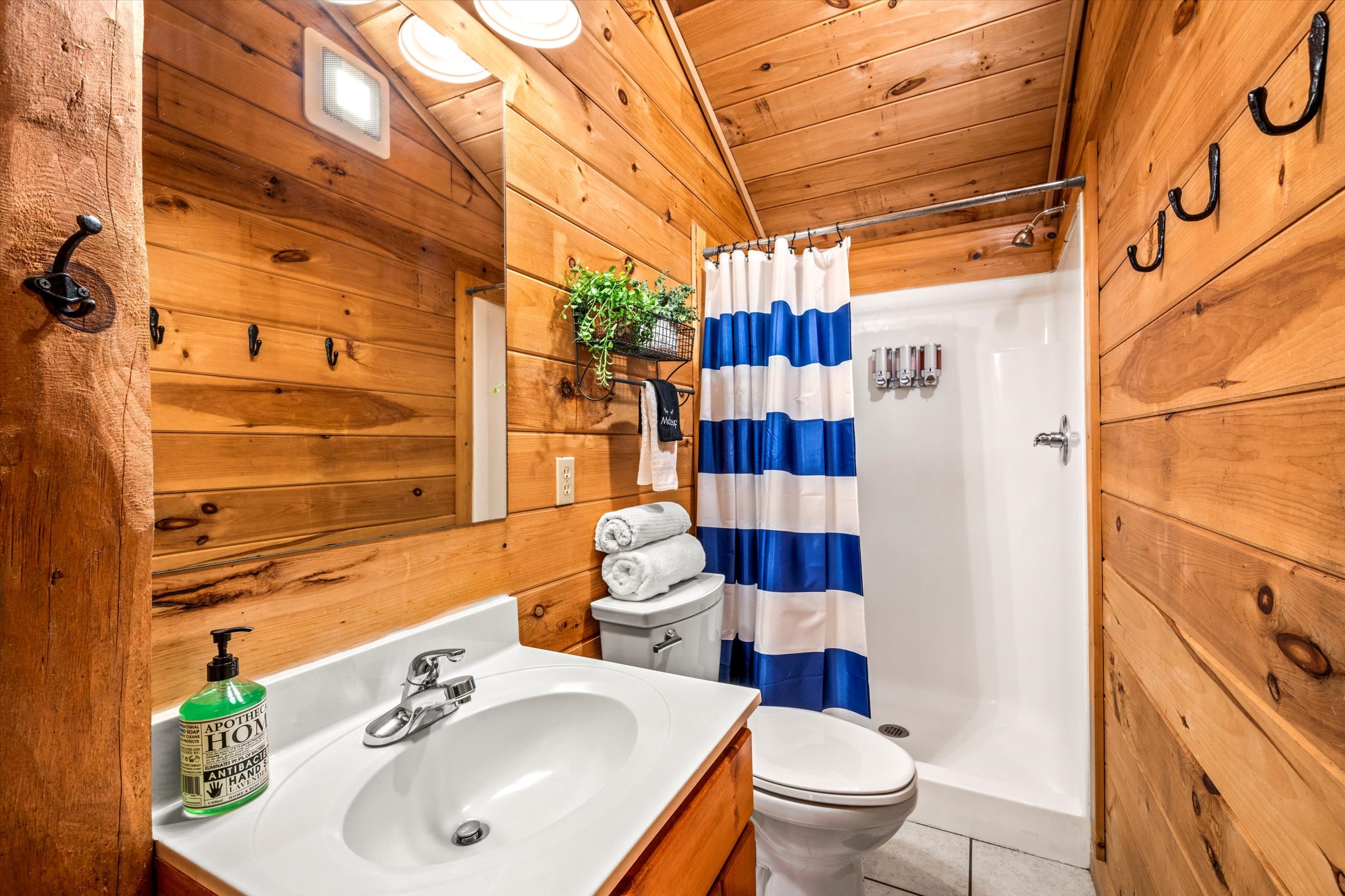The shared upstairs bathroom has a walk in shower and toiletries (body wash, shampoo, conditioner).