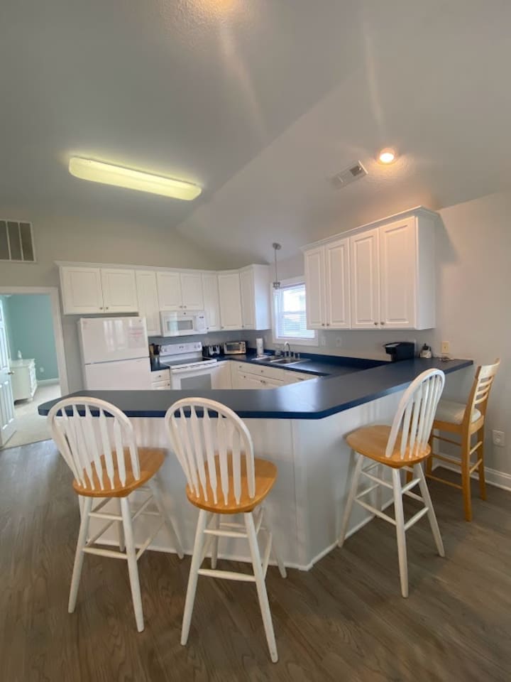 Bright, open kitchen with bar seating for four.