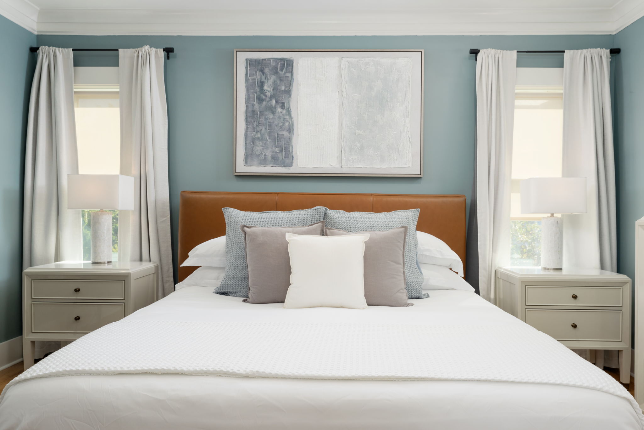 Serene primary bedroom with a comfortable king bed and coastal-inspired design.