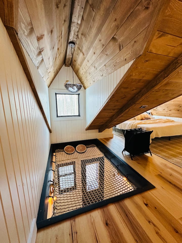 Adding a playful touch, a hammock is ingeniously built into the floor, perfect for lounging and soaking in the serene atmosphere.