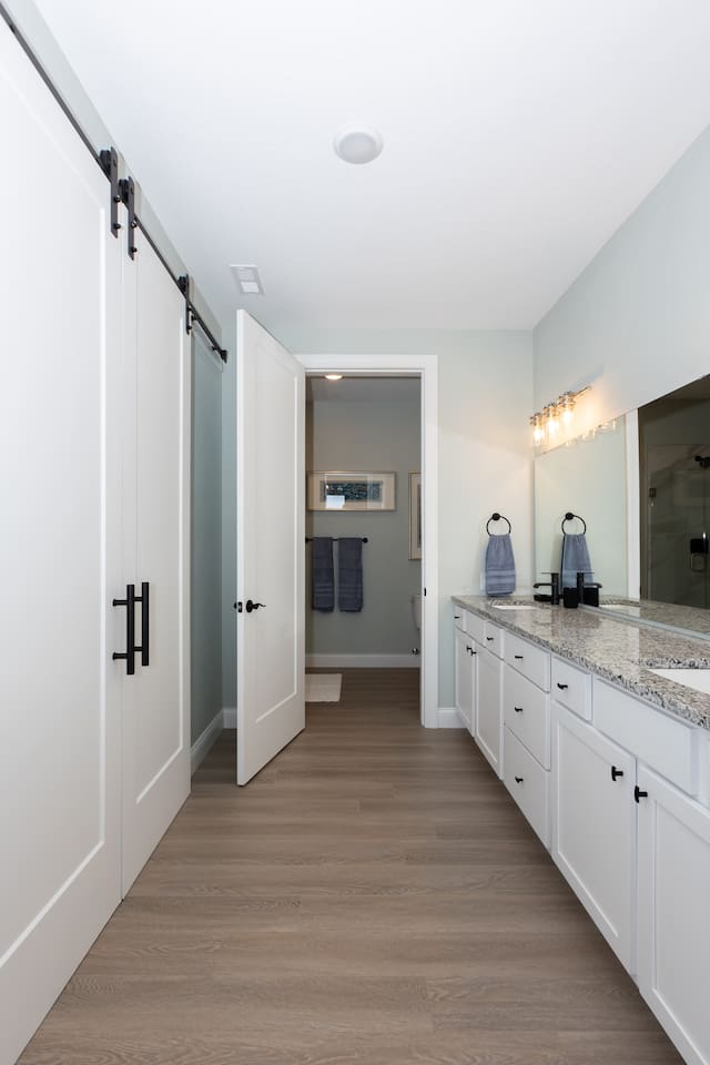 Primary Bathroom ensuite with double basin sinks and large closet.