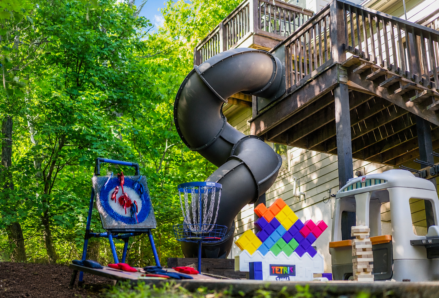 This is where downtime turns into memory-making: kids playing, adults laughing, and everyone drifting between games, the slide, and the mountain air.