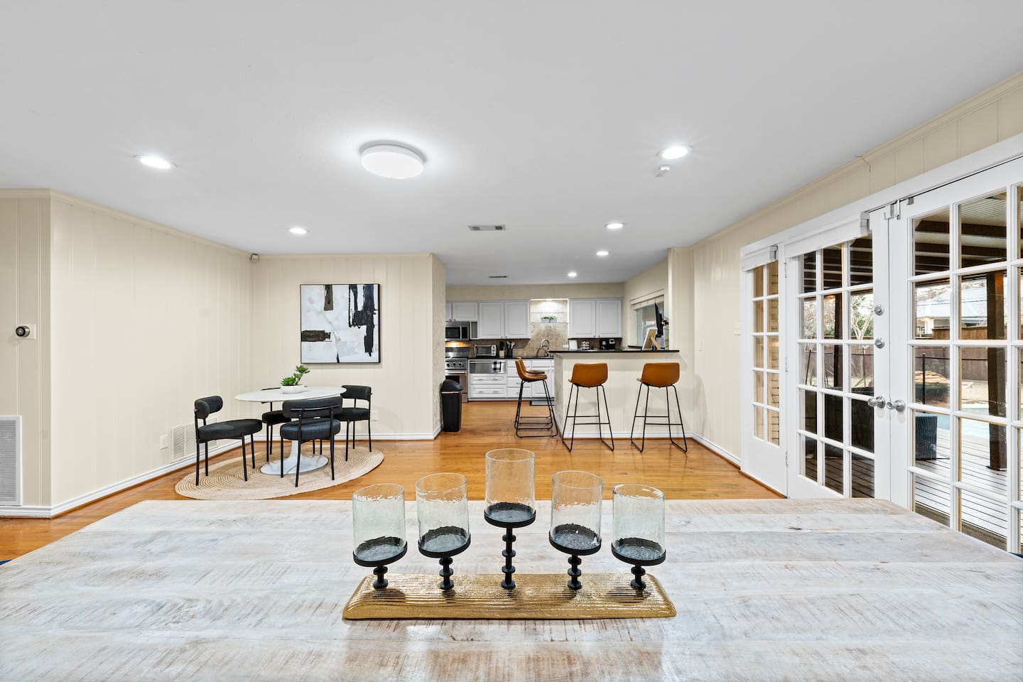 Chic table centerpiece sets the tone—full view of the open-concept kitchen, dining, and lounge space made for entertaining.