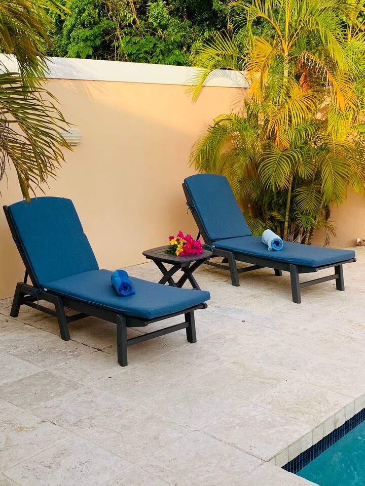 Lounge in the sun while your family enjoys the home's private pool!