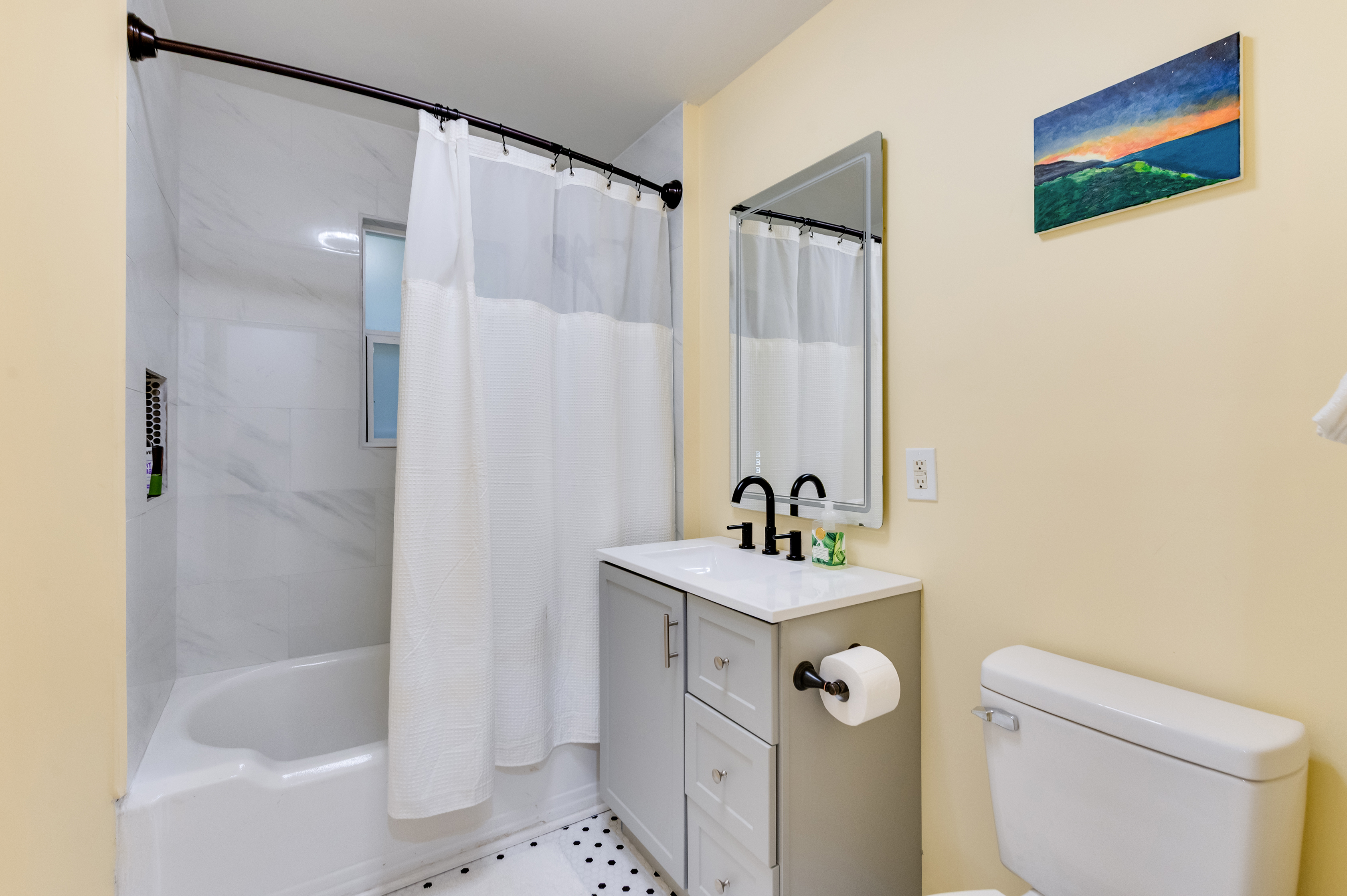 Upstairs Full Bathroom 1: Modern fixtures and soothing colors for your daily refresh!