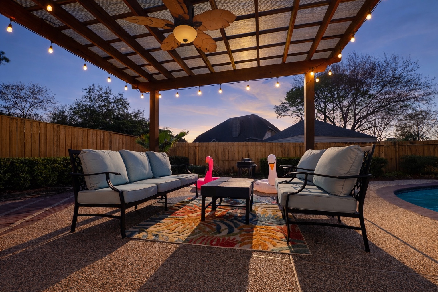 String-lit pergola creates a warm, inviting vibe while you relax poolside — perfect for daytime lounging and cozy evenings.