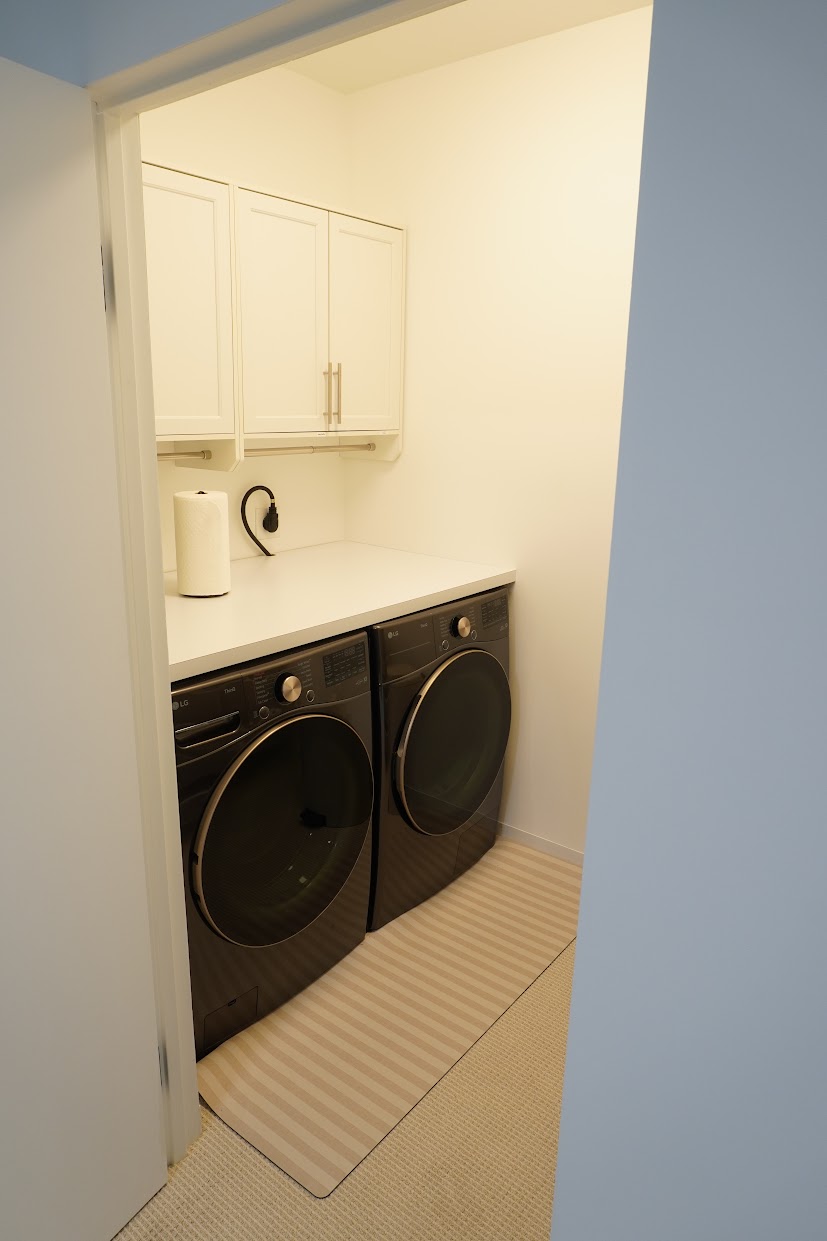 Laundry room with full size washer/dryer.