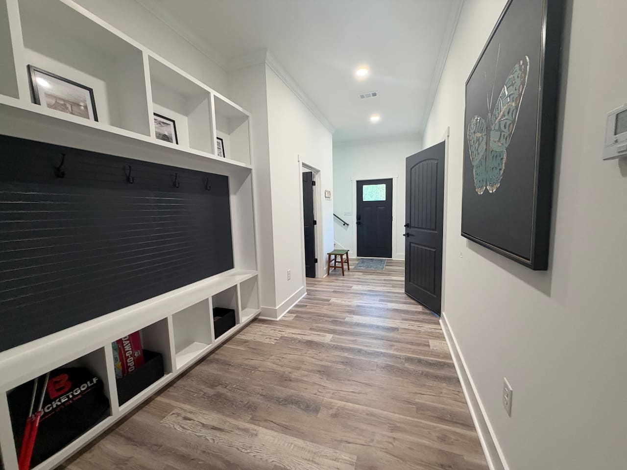 Entry way/mud room on first floor. Board games located under mud room bench. 