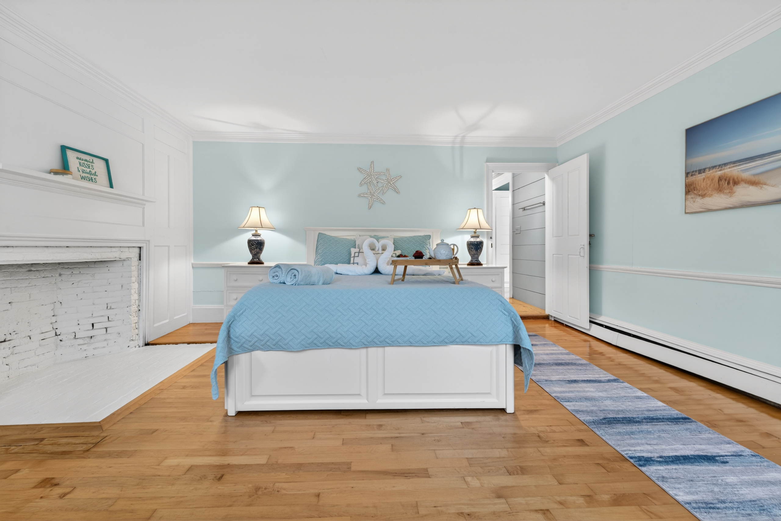 Primary bedroom with a decorative fireplace, and a peaceful atmosphere for restful nights.