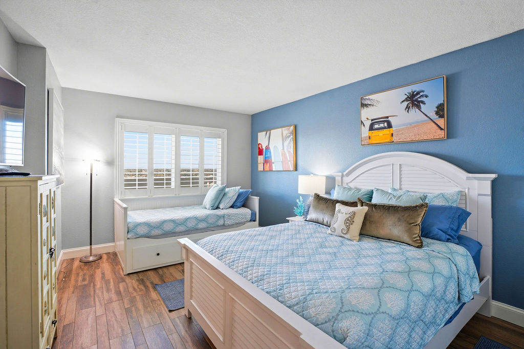 Spacious bedroom with Twin trundle and Queen, also has a TV.