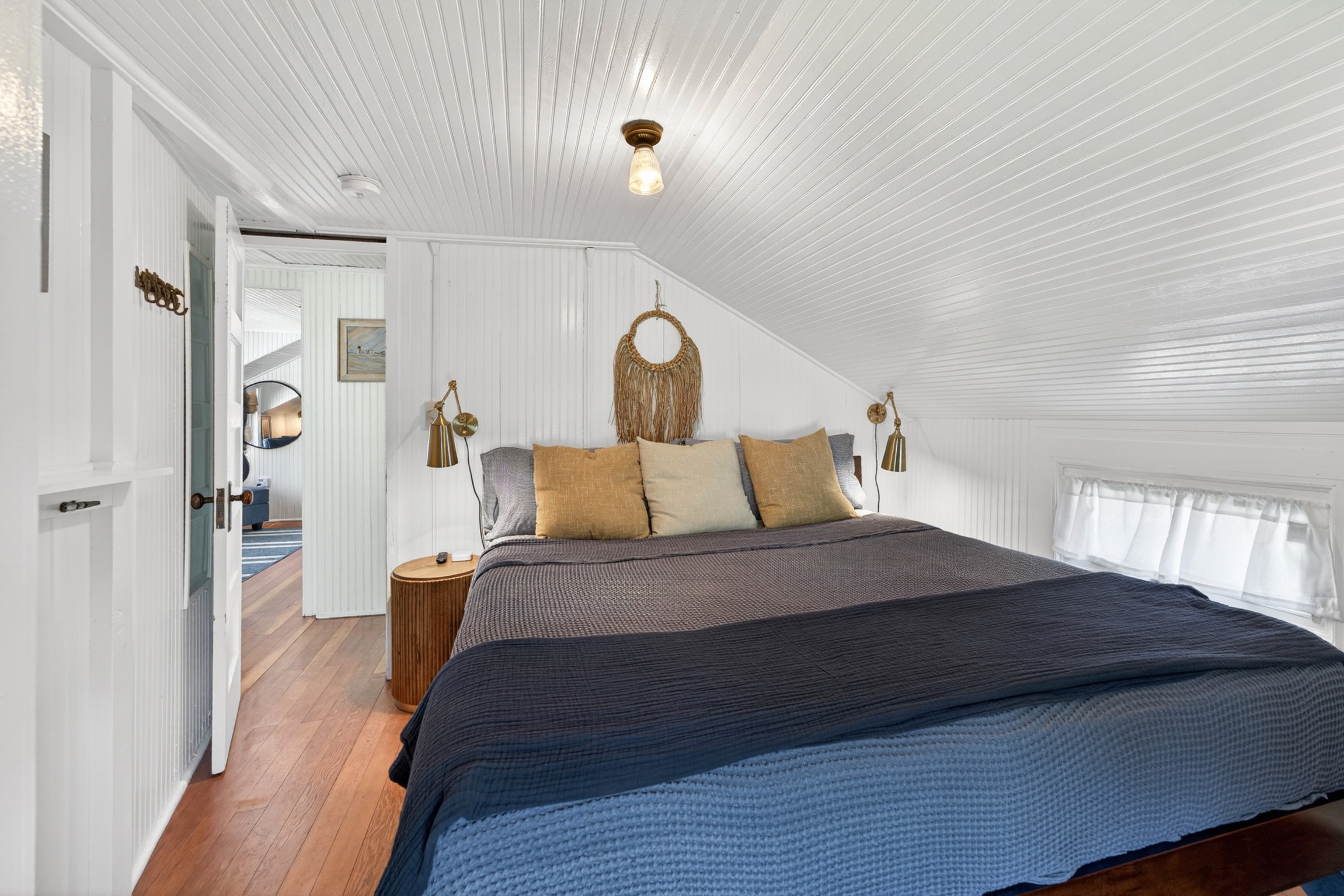 Master bedroom featuring a king bed, smart TV, dresser and closet space.
