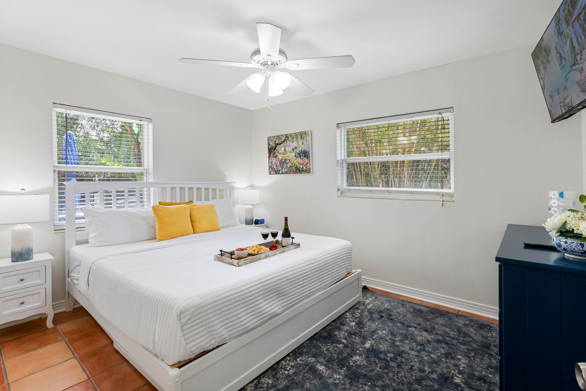 The clean design is accented with modern decor, a plush bed, and a large dresser perfect for extended stays.