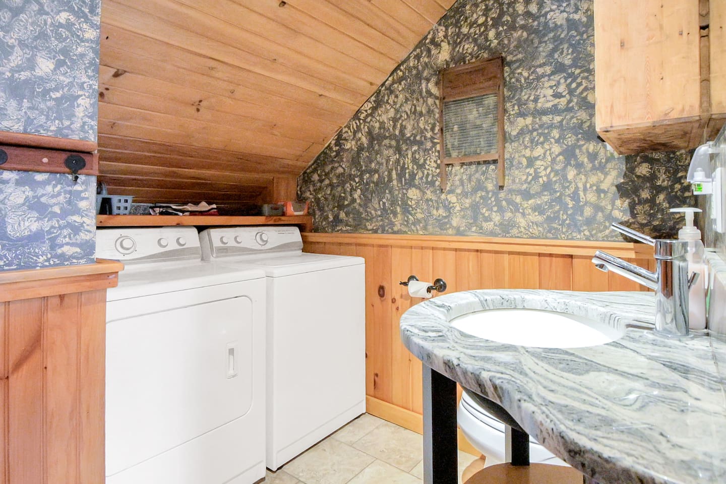The bathroom on the second floor of the home is stocked with a full washer and dryer after a long day on the ski slopes while cleaning up all your gear! 