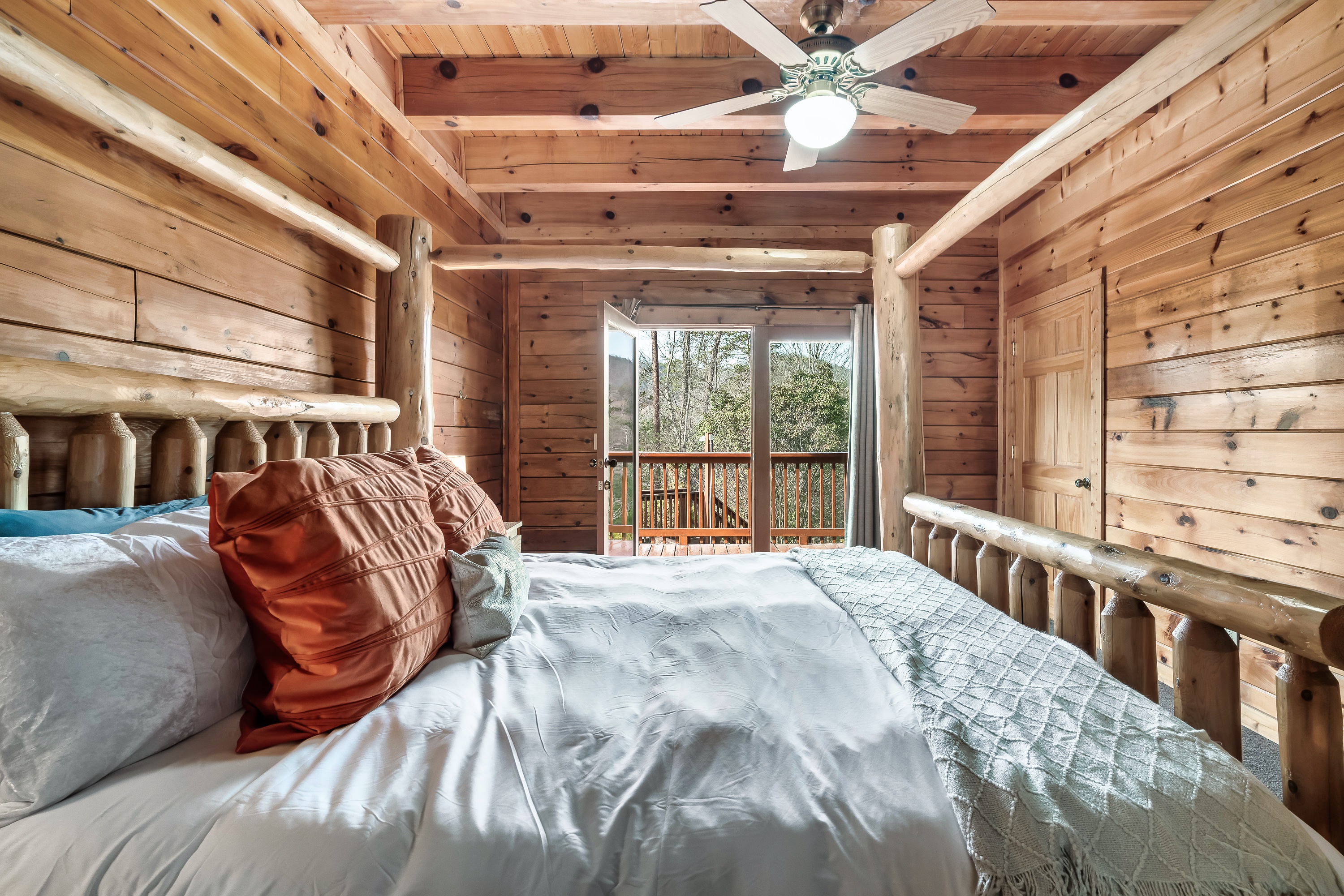 Relax in a peaceful king suite with a cozy fireplace and private bath, offering a calm escape within the cabin.
