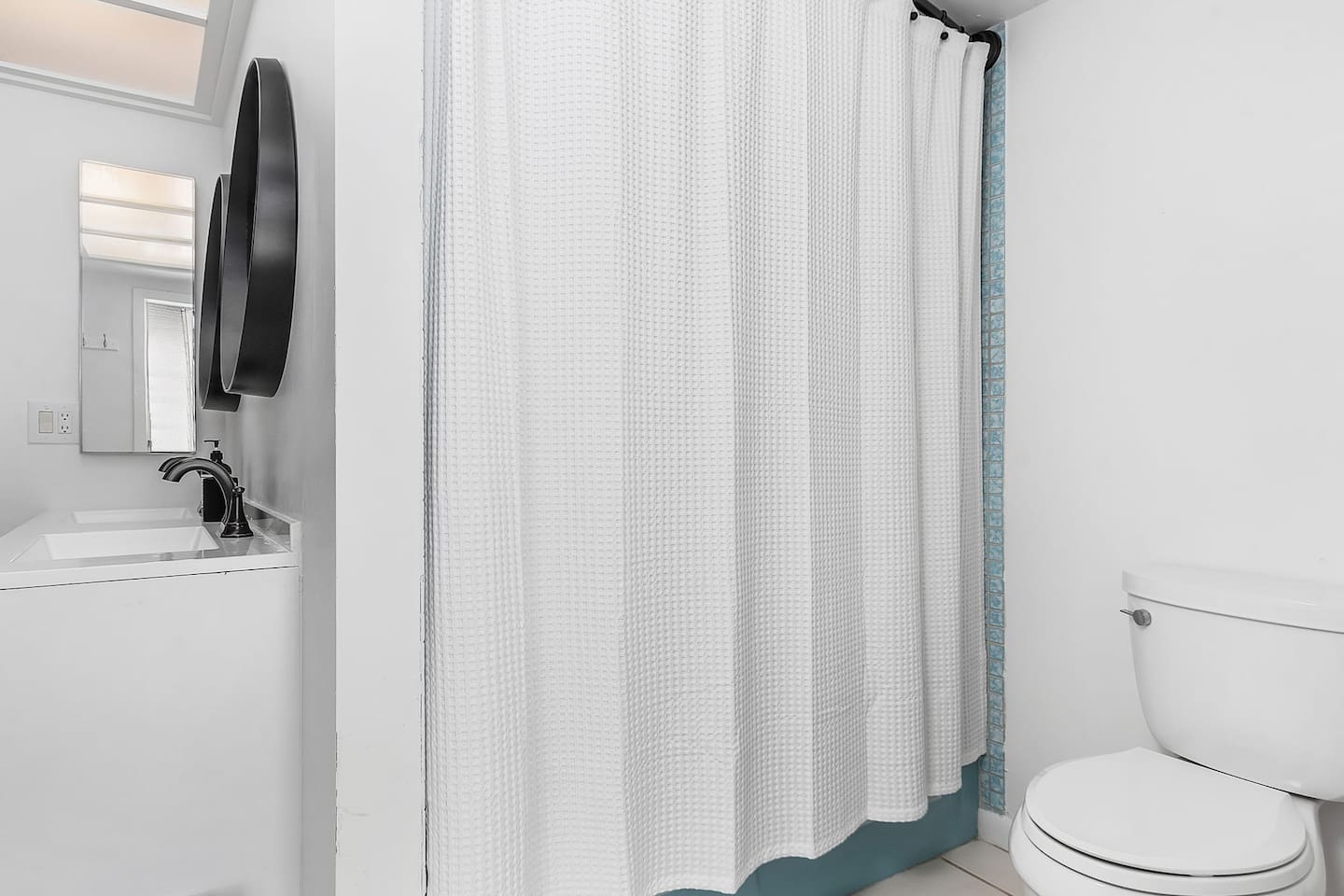 Guest bathroom featuring a versatile tub-shower combo, ideal for relaxation and convenience!