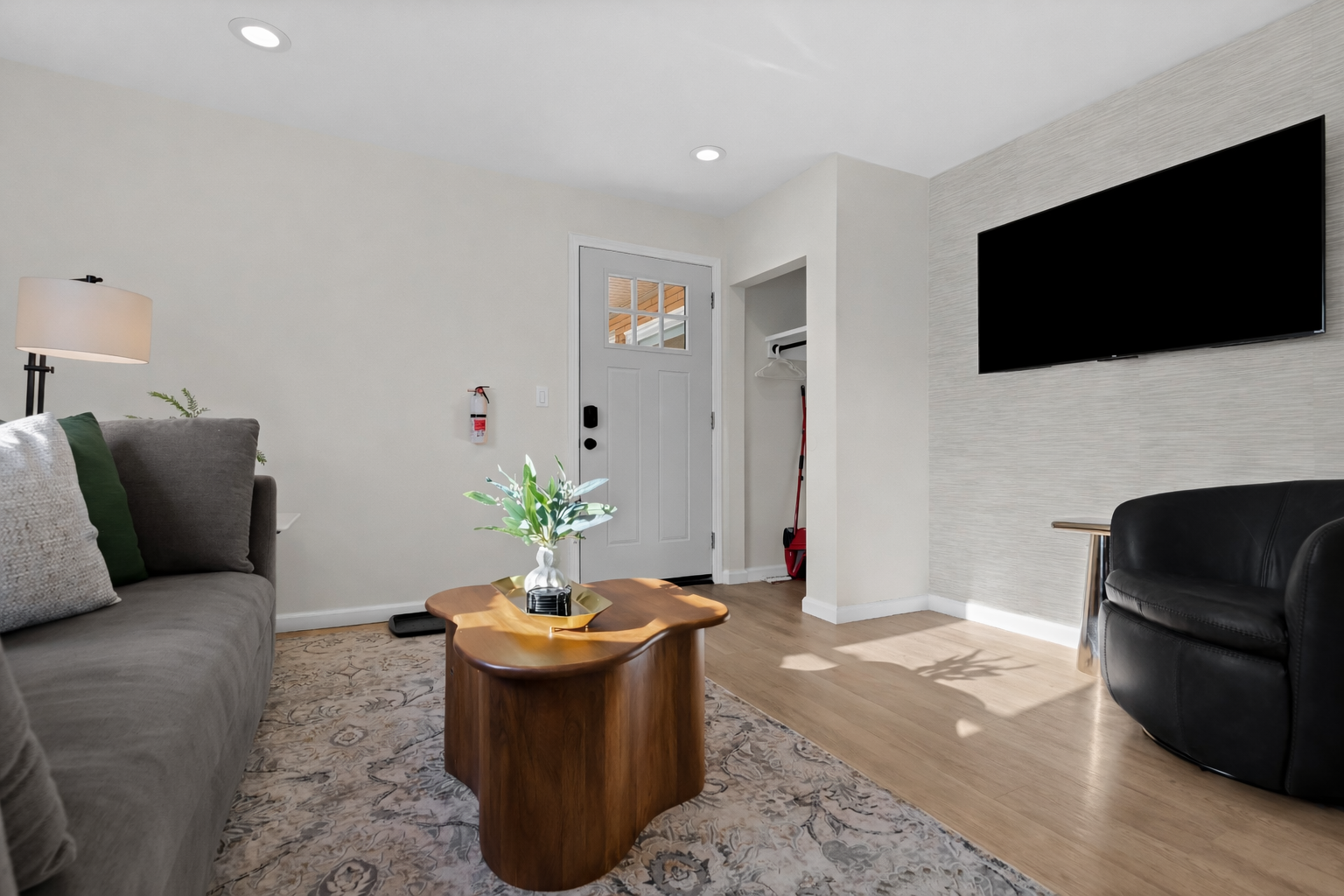 Bright living area with smart TV, modern décor, and comfortable seating—designed for relaxing, streaming your favorites, or enjoying time together.