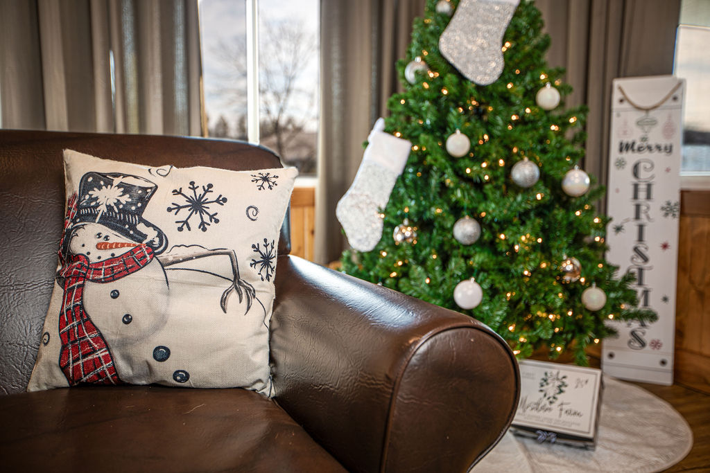 Festive holiday pillows and decor add to the charm.