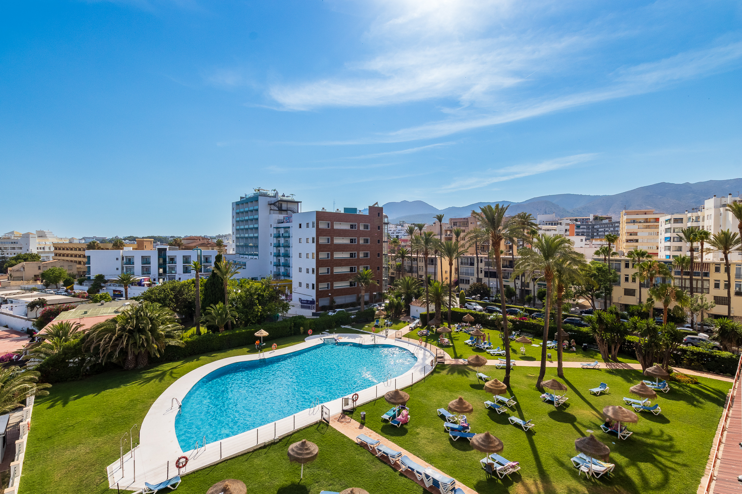 Shared pool and landscaped grounds with city and mountain views.