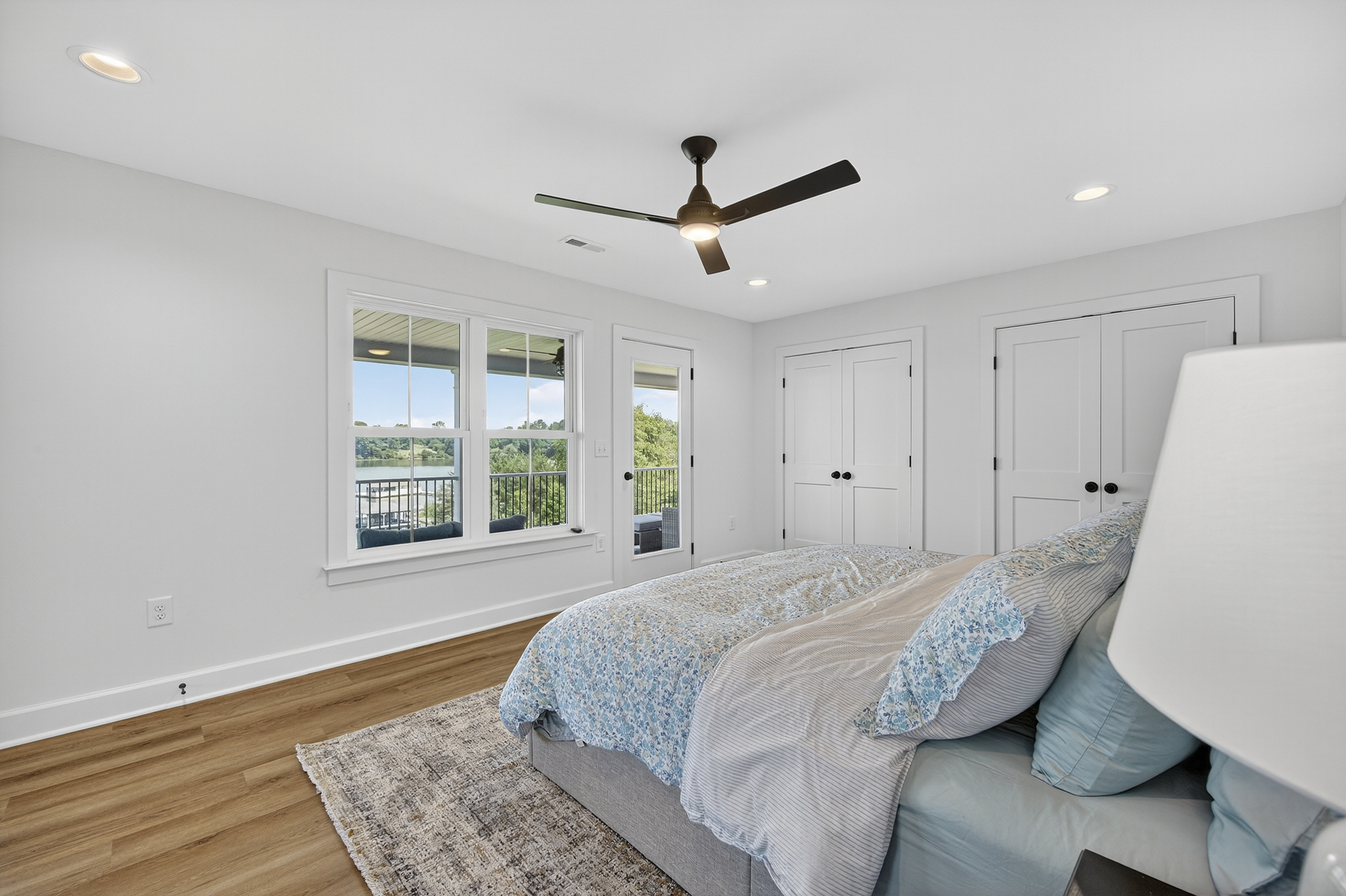 King-size comfort with private balcony access and sweeping lake views.