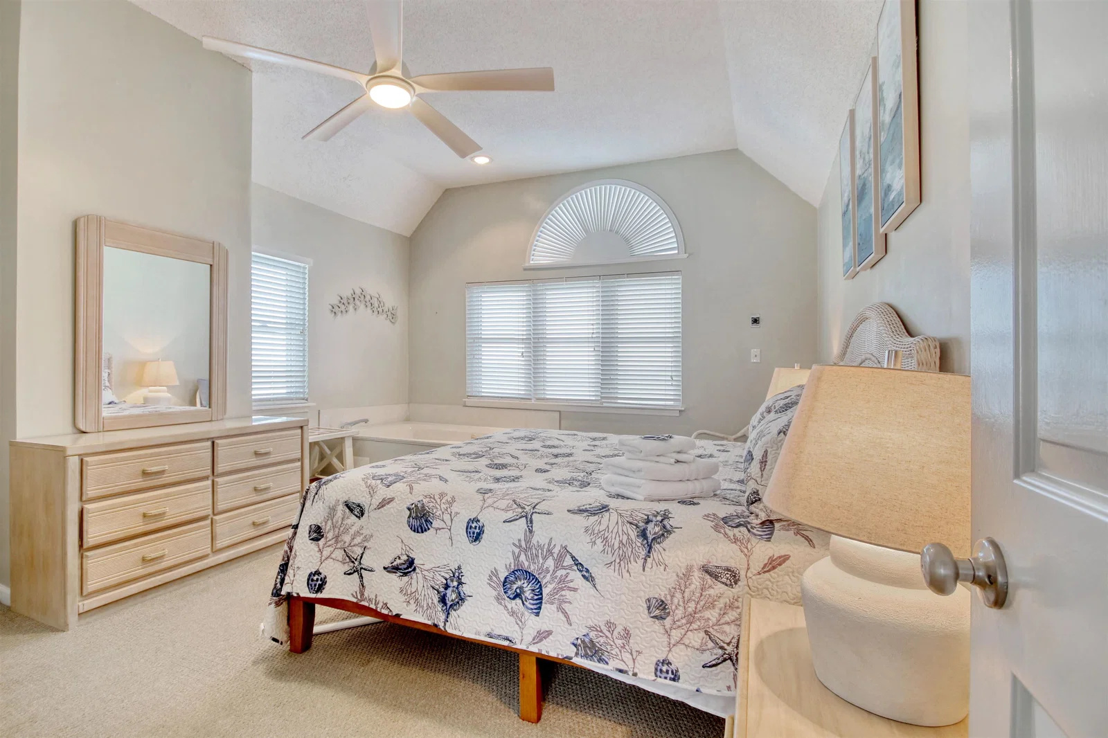 Primary bedroom with vaulted ceiling