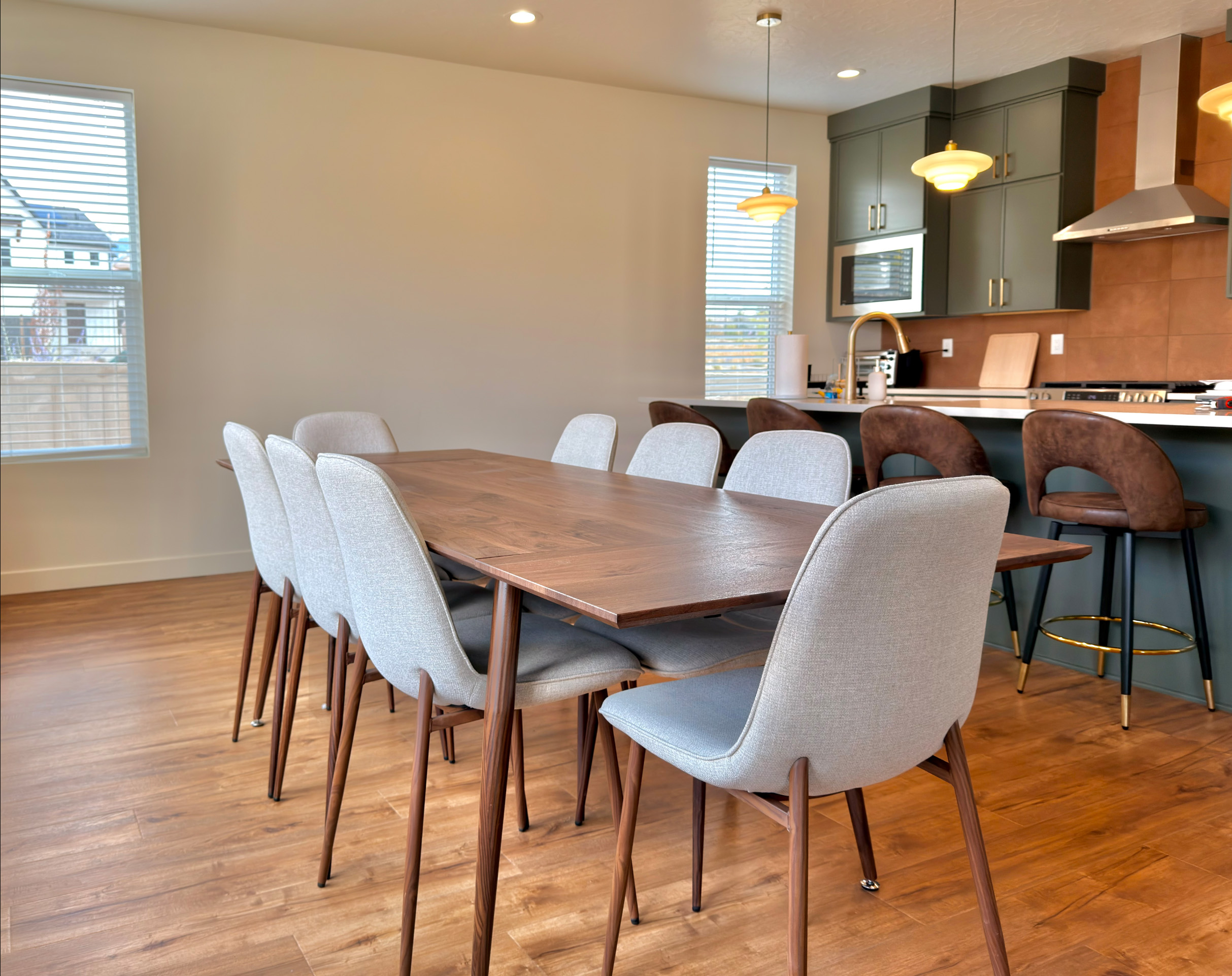 Elegant dining table for eight with soft lighting and an open layout, ideal for group dinners or gatherings.